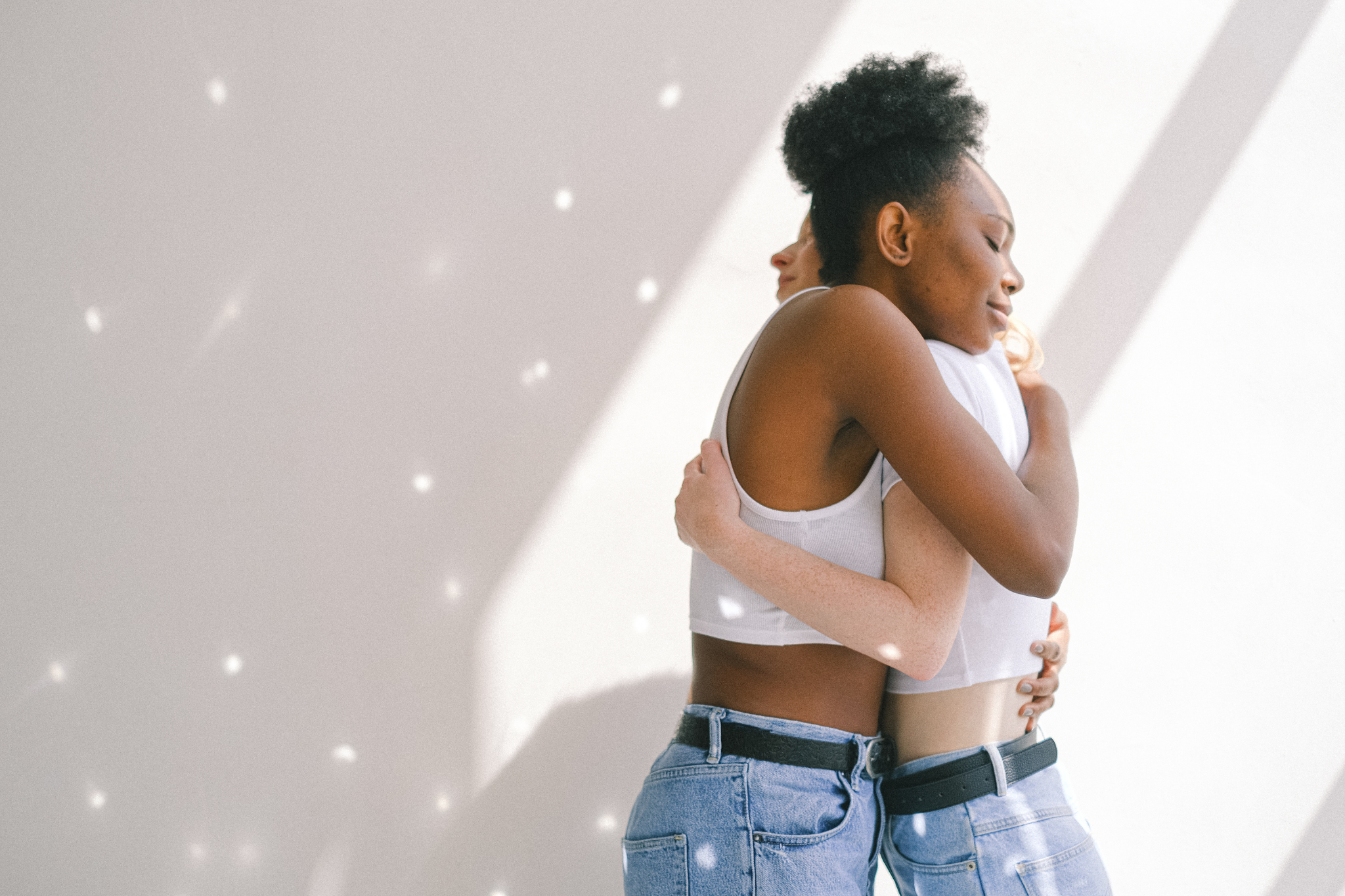 Two women share a warm, intimate embrace, showing the deep connection possible through trust rebuilding after cheating. affair recovery counseling in Portland, Oregon,