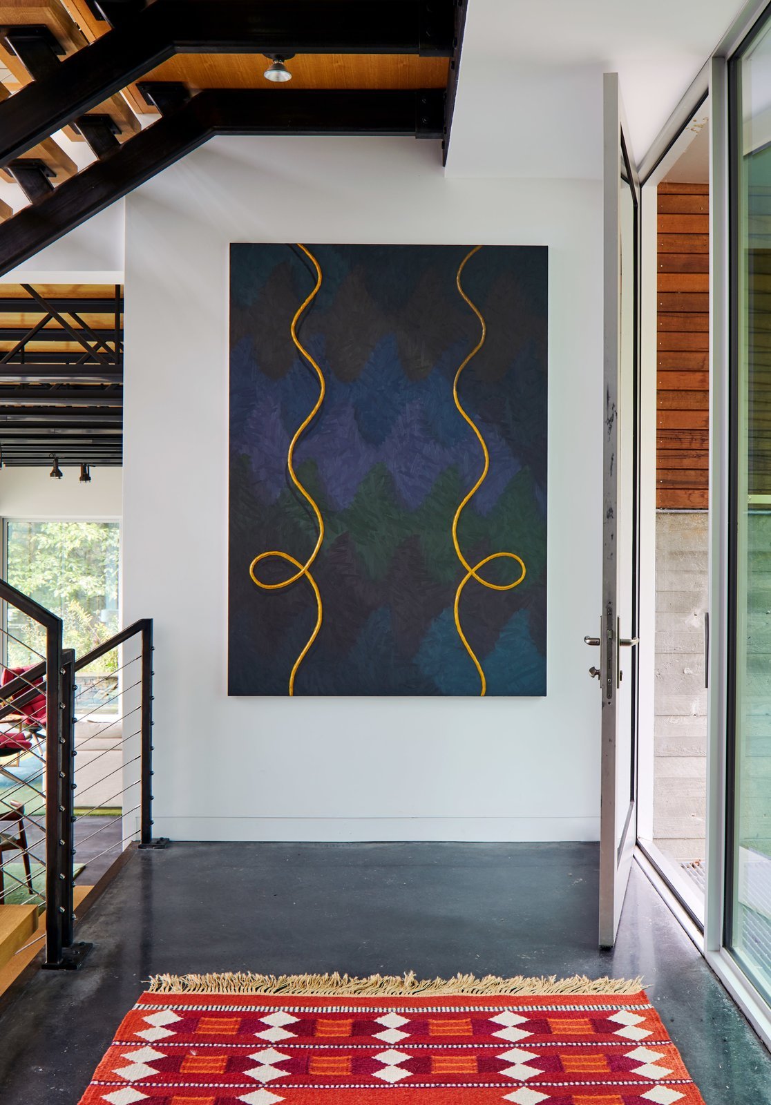   Alex Olson's Cast, which is oil and modeling clay on canvas, hangs above a vintage Swedish rug.  