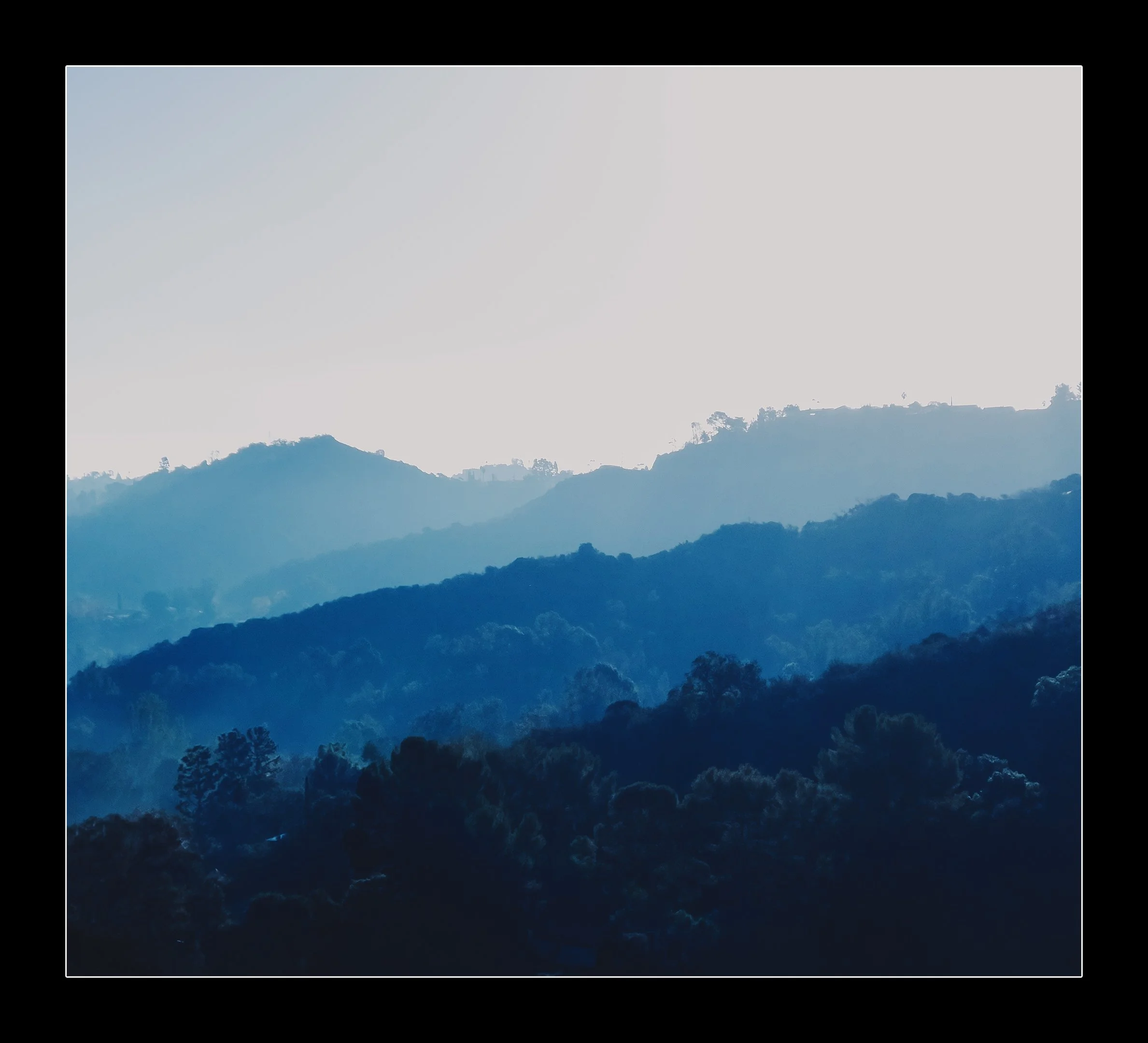Fog rolls over the green hills of Sherman Oaks in this blue tinted capture of a SoCal morning.