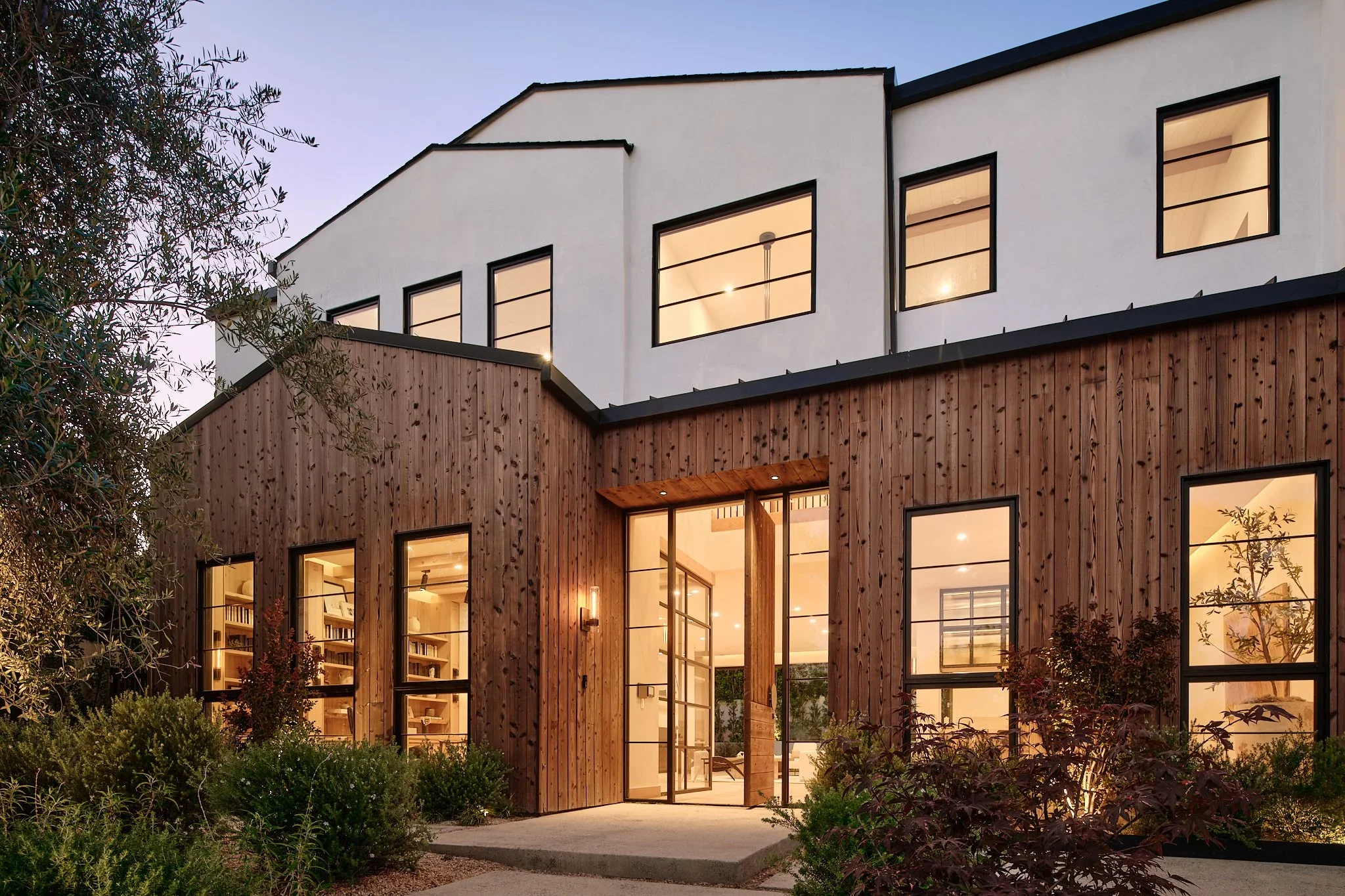 Exterior of a luxury custom home showing interior lighting.