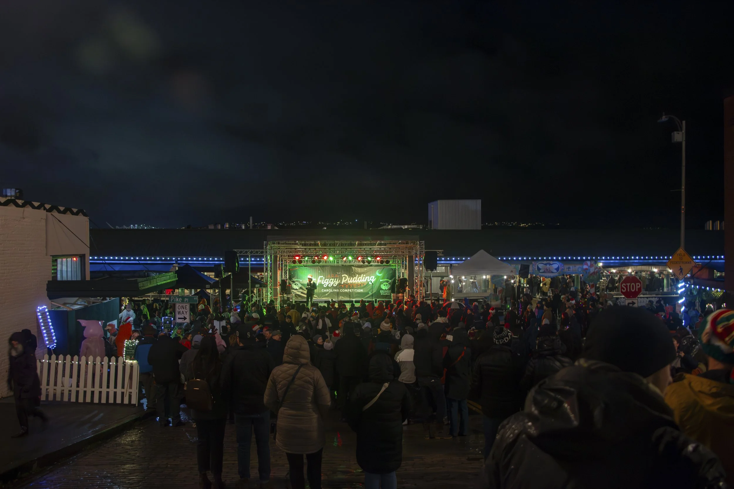 The crowd gathers as they start to announce the top three winners of the 38th annual Great Figgy Pudding Caroling Competition in Pike Place Market Seattle, Wash. on Dec. 1, 2023.