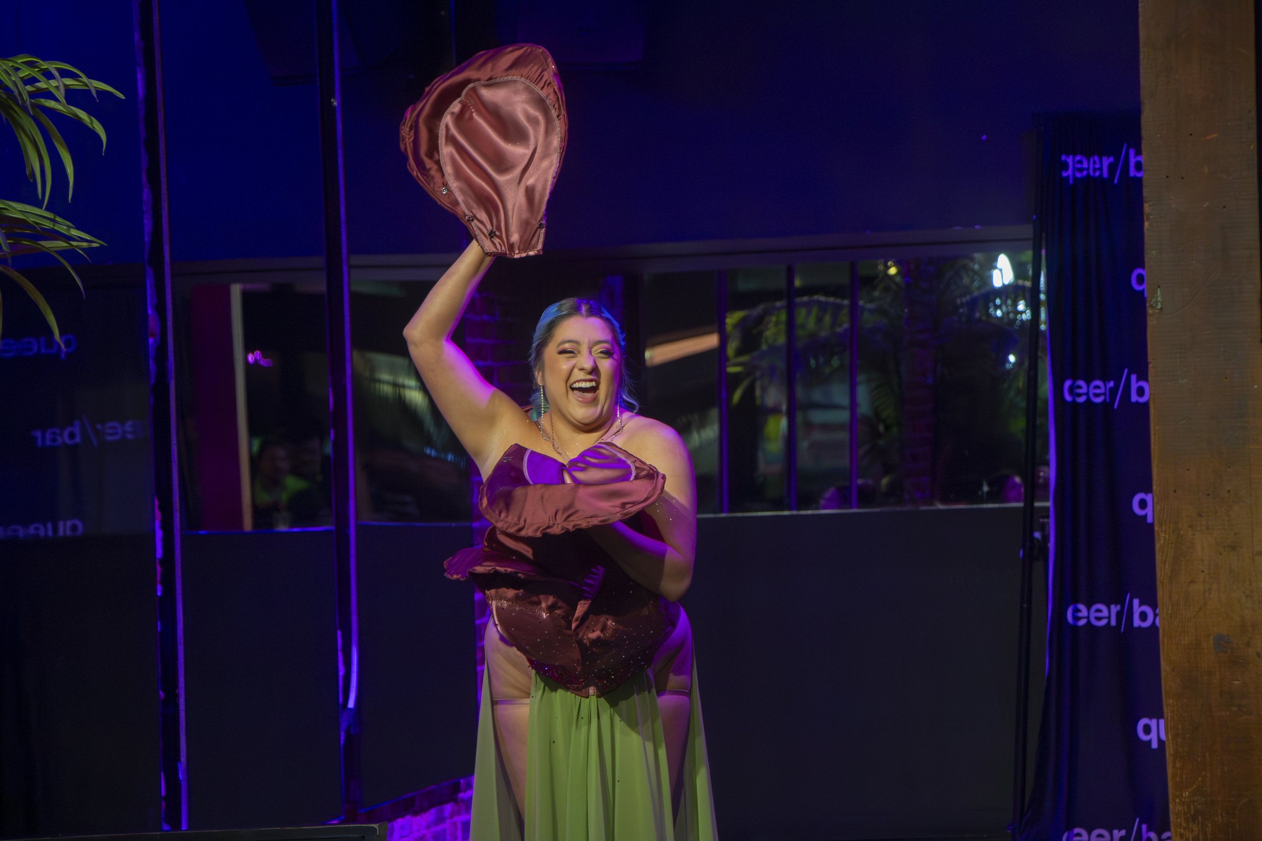 Burlesque performer and drag queen Scarlett Folds peeling off the petals off her outfit during her number at the Bronze Babez show at Queer/Bar, Seattle Wash. Nov. 29, 2023.
