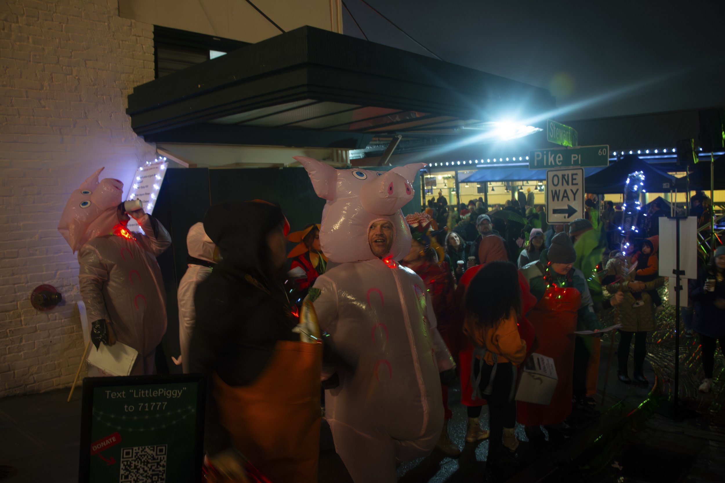 The Little Piggy caroling group all preparing for their next song during the 38th annual Great Figgy Pudding Caroling Competition in Pike Place Market Seattle, Wash. on Dec. 1, 2023.