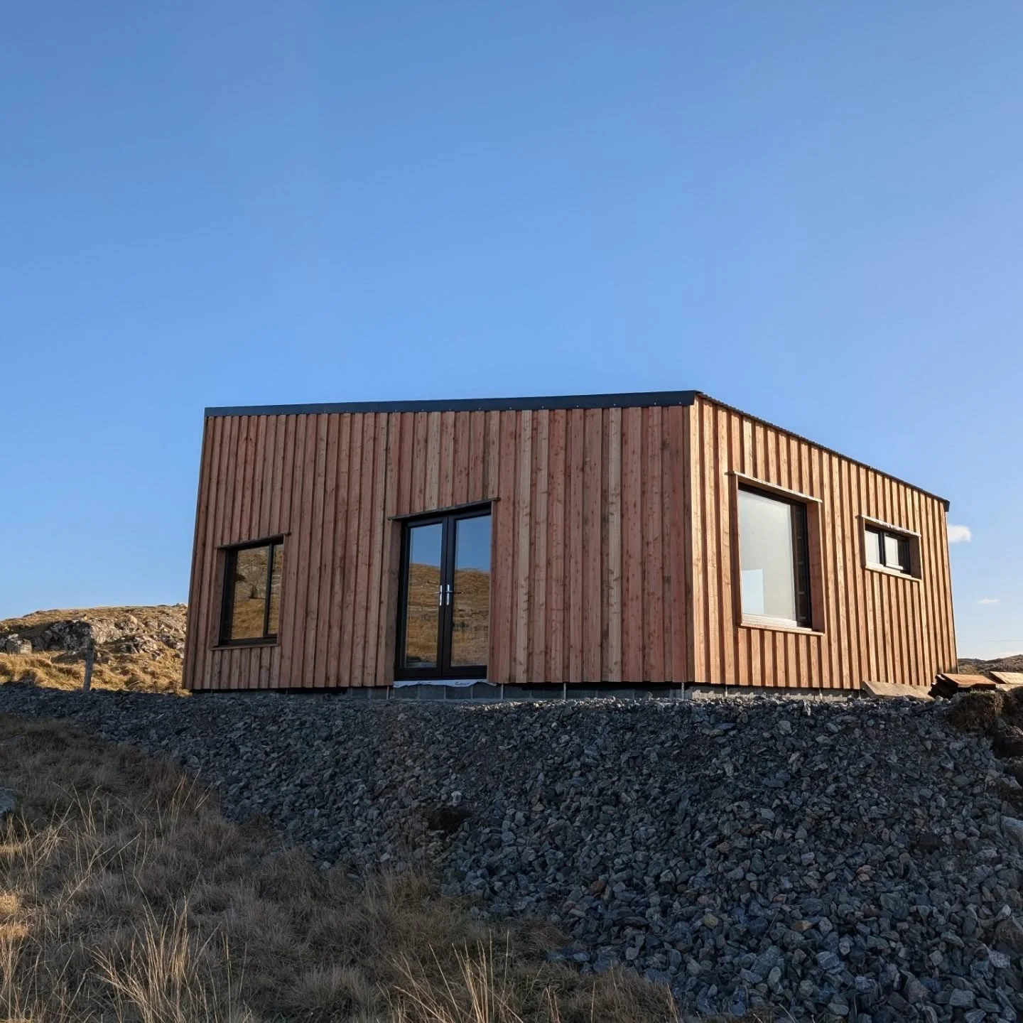 Current Project - A simple 56m2 single-bedroom house on the west side of Lewis. 🛠️ I've been working hard on this build over the winter, and now the exterior is almost complete with the Scottish larch looking great in the near-spring sunshine ☀️