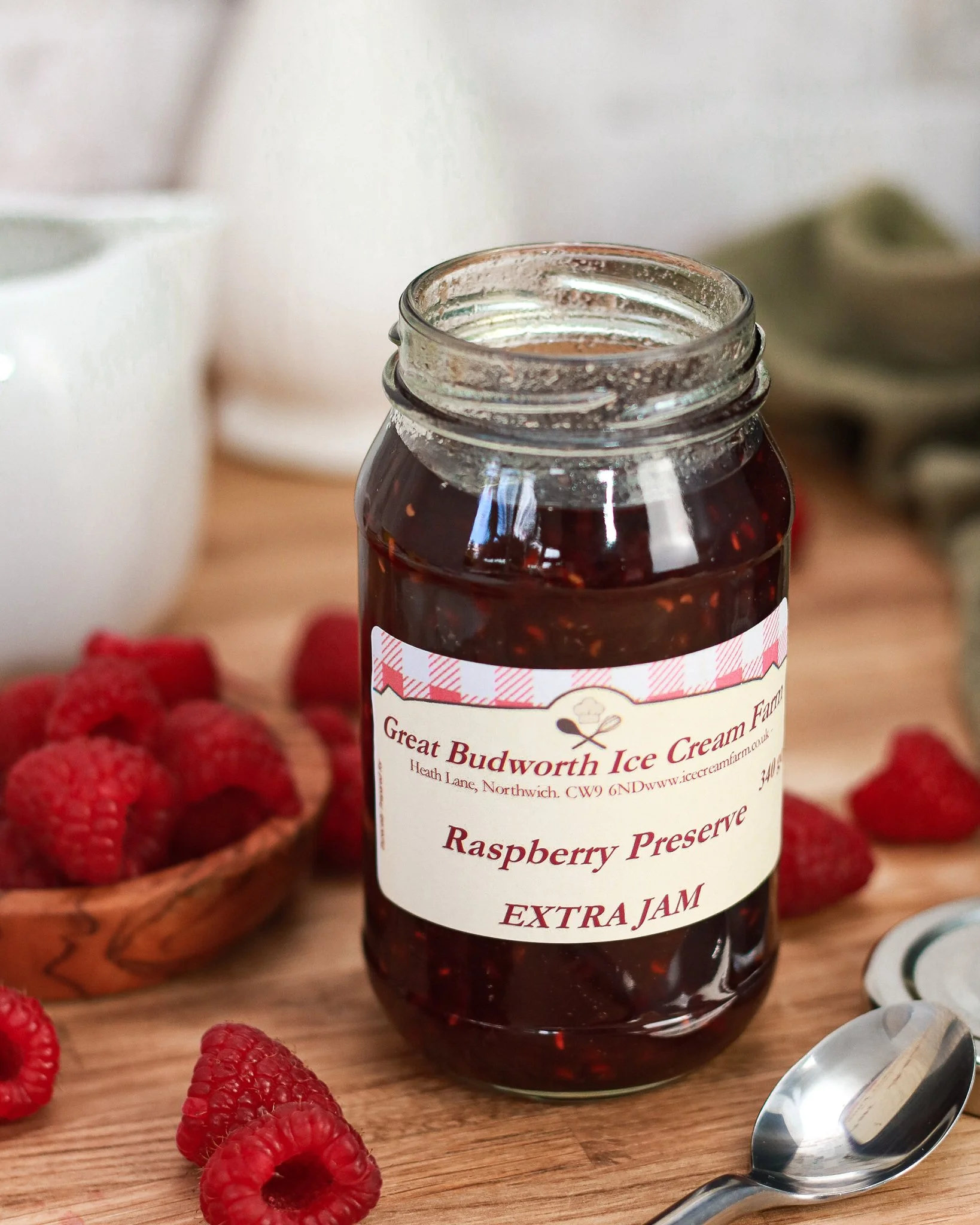 close up of open raspberry jam jar