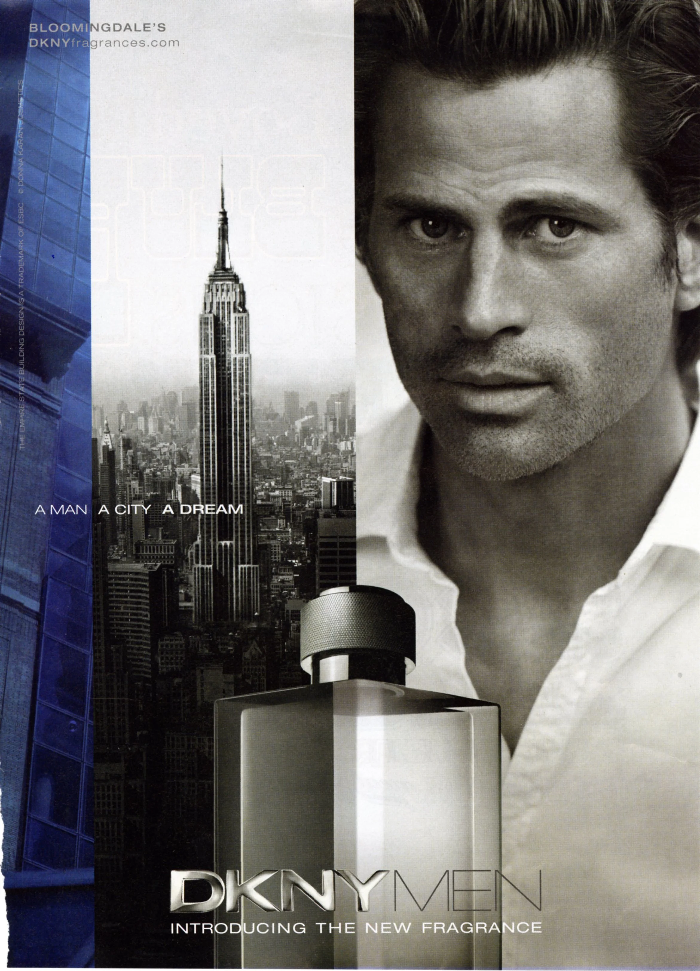 An ad for DKNY men that says "A Man A City A Dream" with a black and white image of the Empire State Building on the left and an attractive man on the right