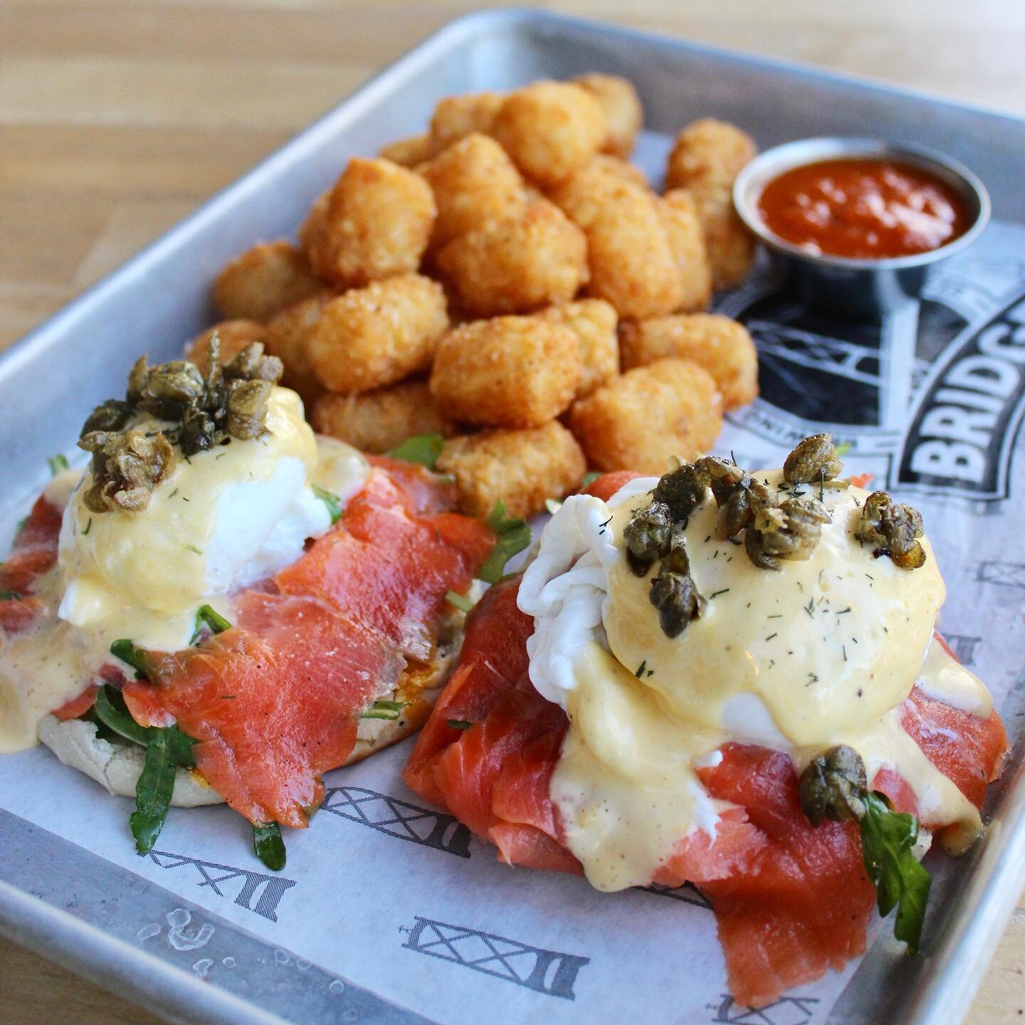 Check out our newest brunch feature: The Smoked Salmon Benny 🍳

@tworiversmeats eggs, smoked salmon, fried capers, arugula tossed in lemon oil and house made hollandaise all placed on top of an English muffin and served with tater tots and house mad