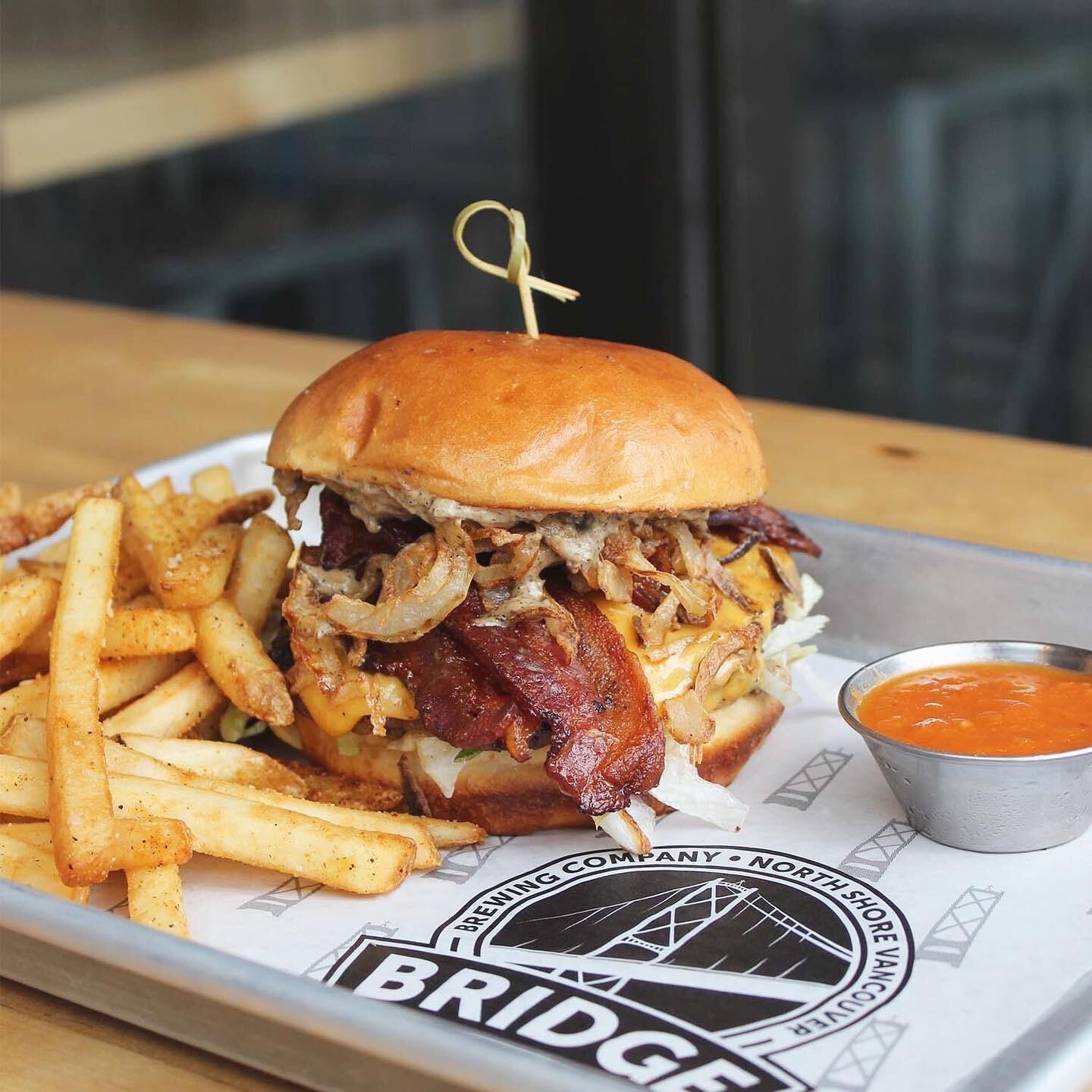 I said goddamn! Introducing our newest burger feature: The Peppercorn Royale with Cheese. @tworiversmeats patty, bacon, house made peppercorn cream sauce, iceberg lettuce, American cheese and crispy onions all between a toasted brioche bun. Served wi