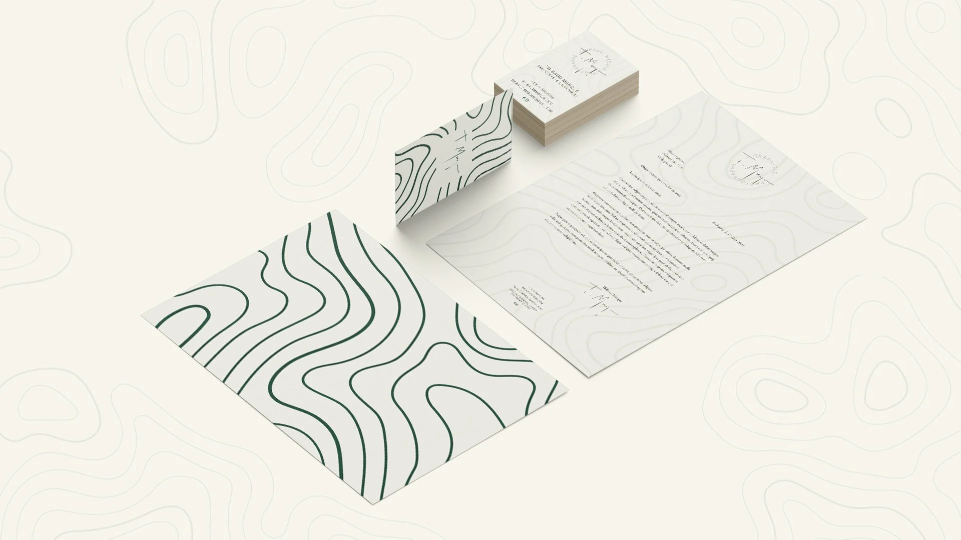 Papier à bulles, cartes de visite et lettre imprimée avec motifs de lignes ondulées et contour topographique en noir et blanc.