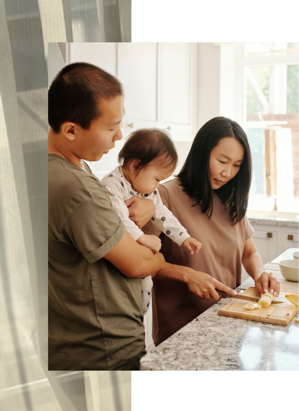 family of four laughing and looking at each other