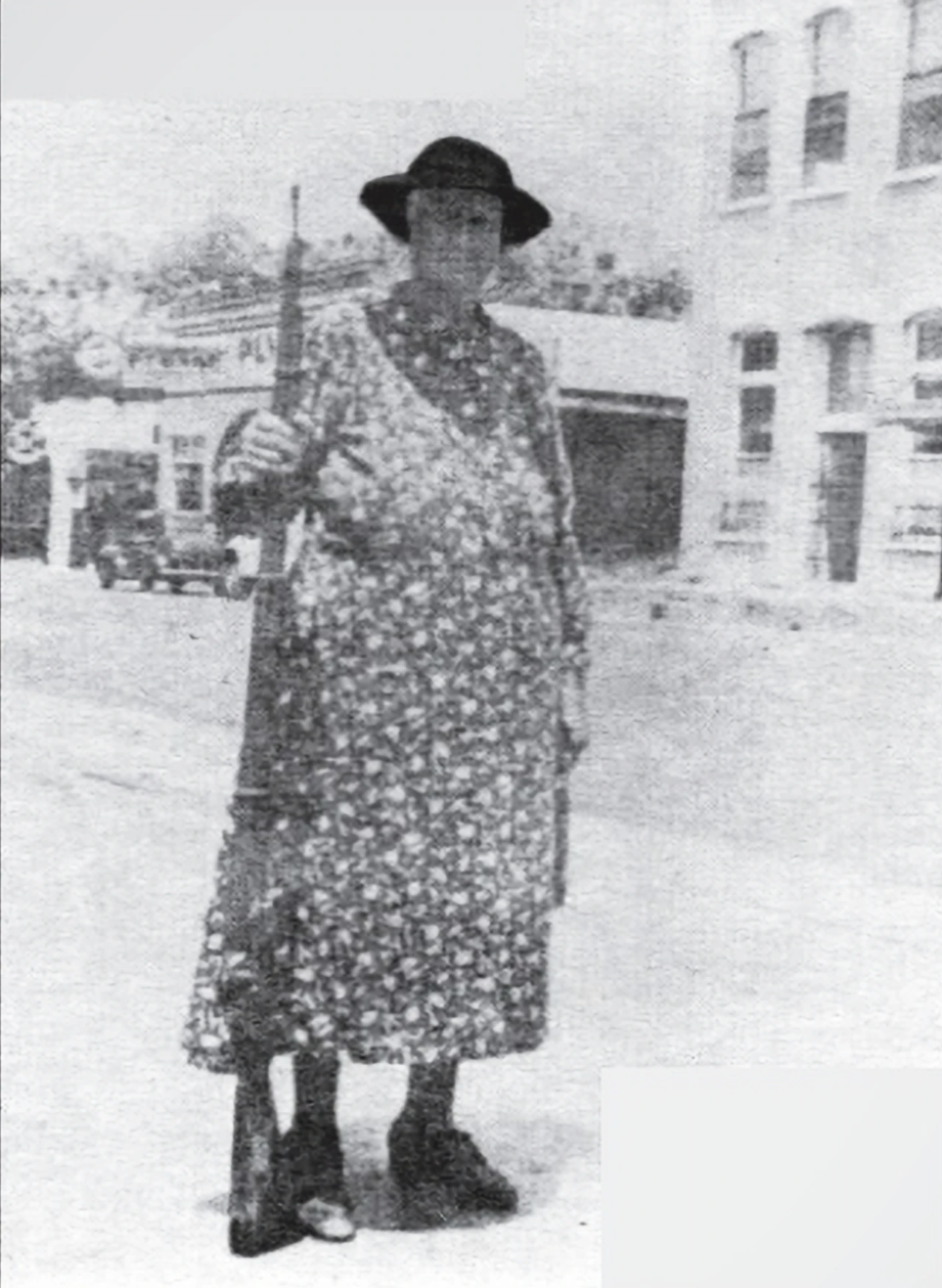 "Susan Batten Wiggins (1939) strikes an imposing figure near the corner of Main and Broad. Mrs. Wiggins was born in Hernando County in 1879. Behind her is the old Zeke Rogers Dodge dealership, originally a Ford dealership in 1914 and currently the Ho