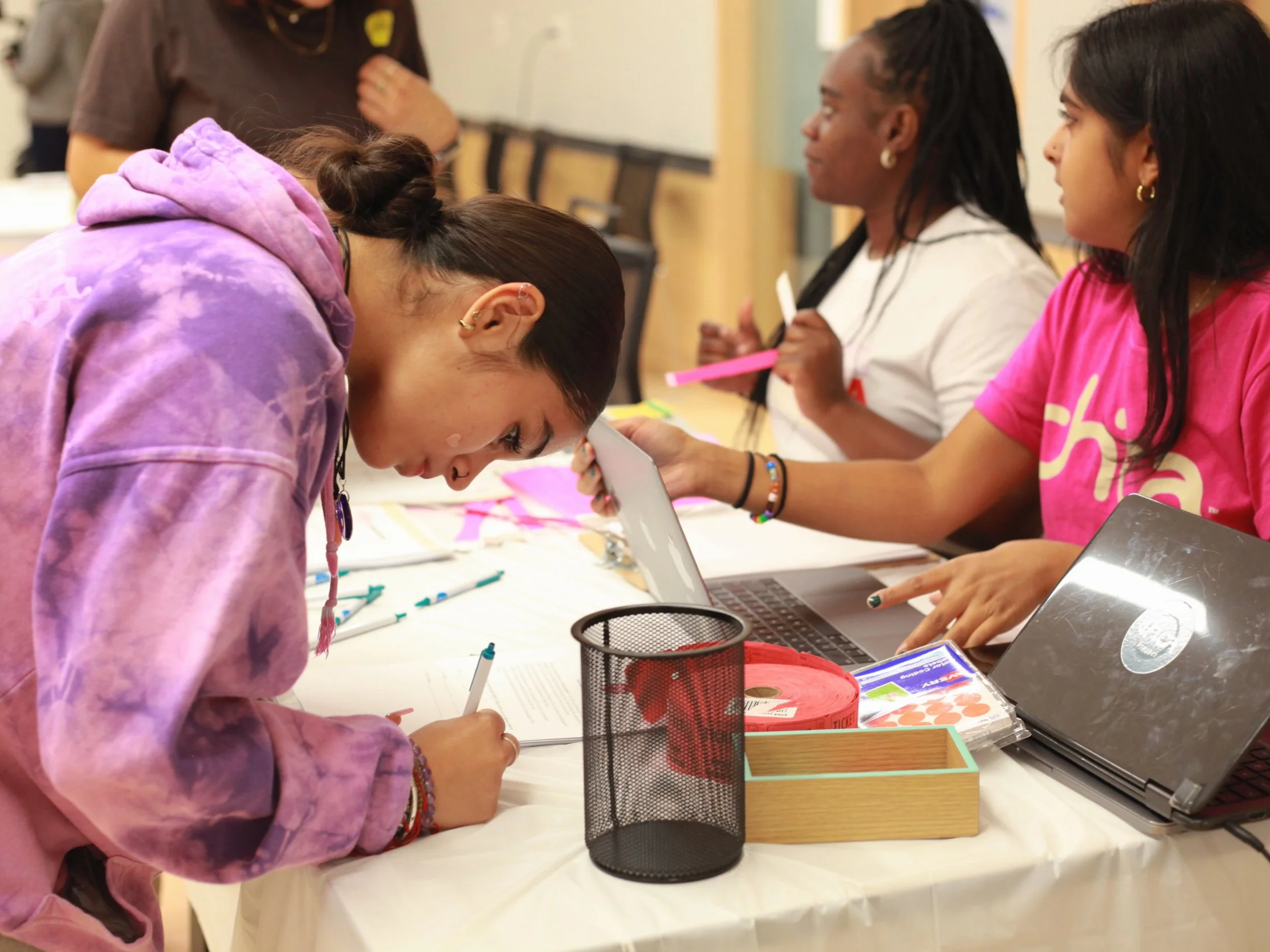 Two Latina girls collaborating on a writing activity during a Chicas in Bloom program session at a Boston Public School, building leadership skills and identity through Chica Project's 3-month curriculum