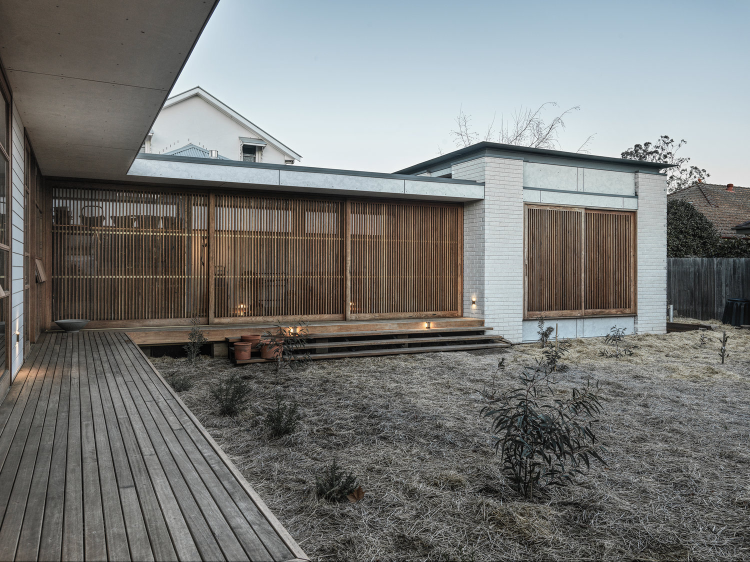 Exterior view of multi panel sliding hardwood privacy/sunscreens made from recycled Australian hardwood