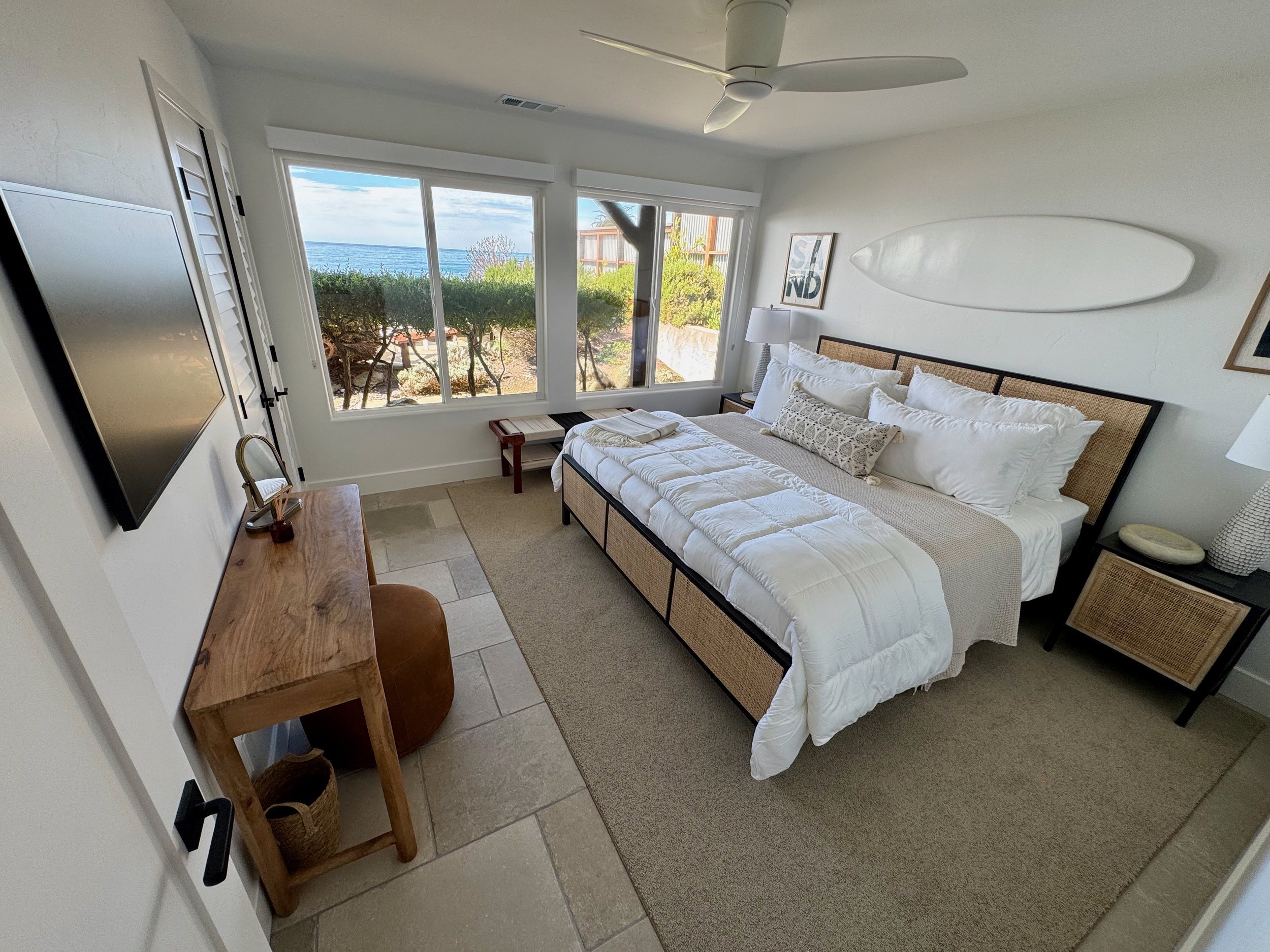 "Surf" bedroom, smaller downstairs guest room with king bed & Frame TV.