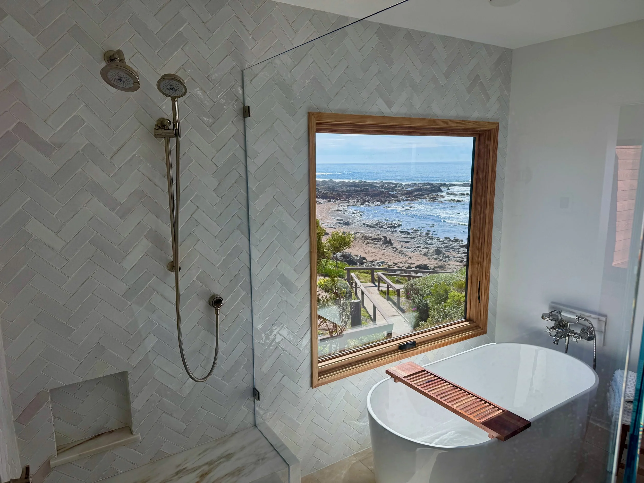 New master bath shower and soaking tub with view of Harvey Beach. (Shades for privacy)