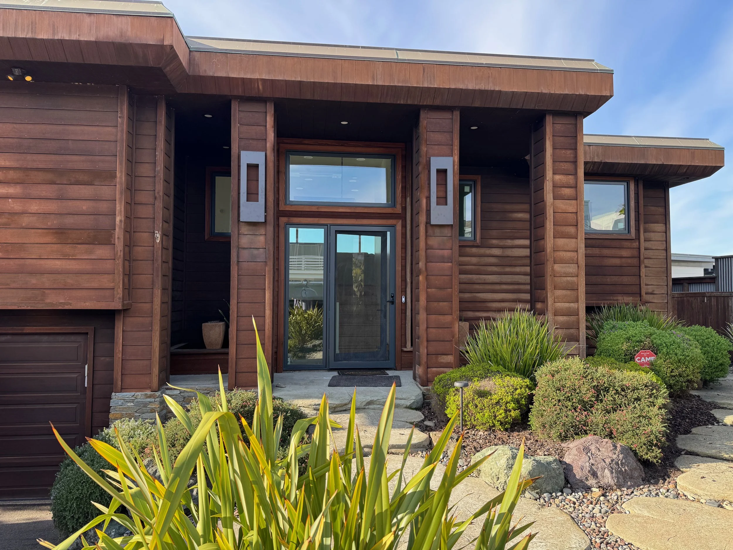 Front door and 2 car garage with EV car charger.
