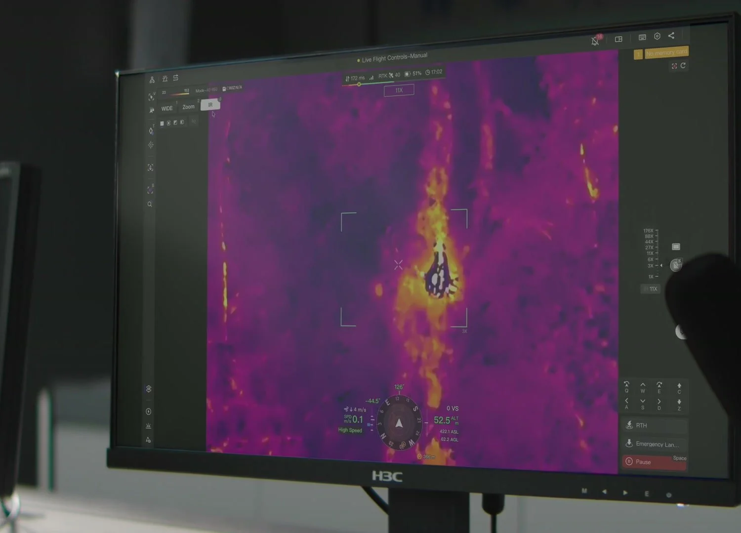 Control-room monitor showing a live thermal feed from the Matrice 5TD
