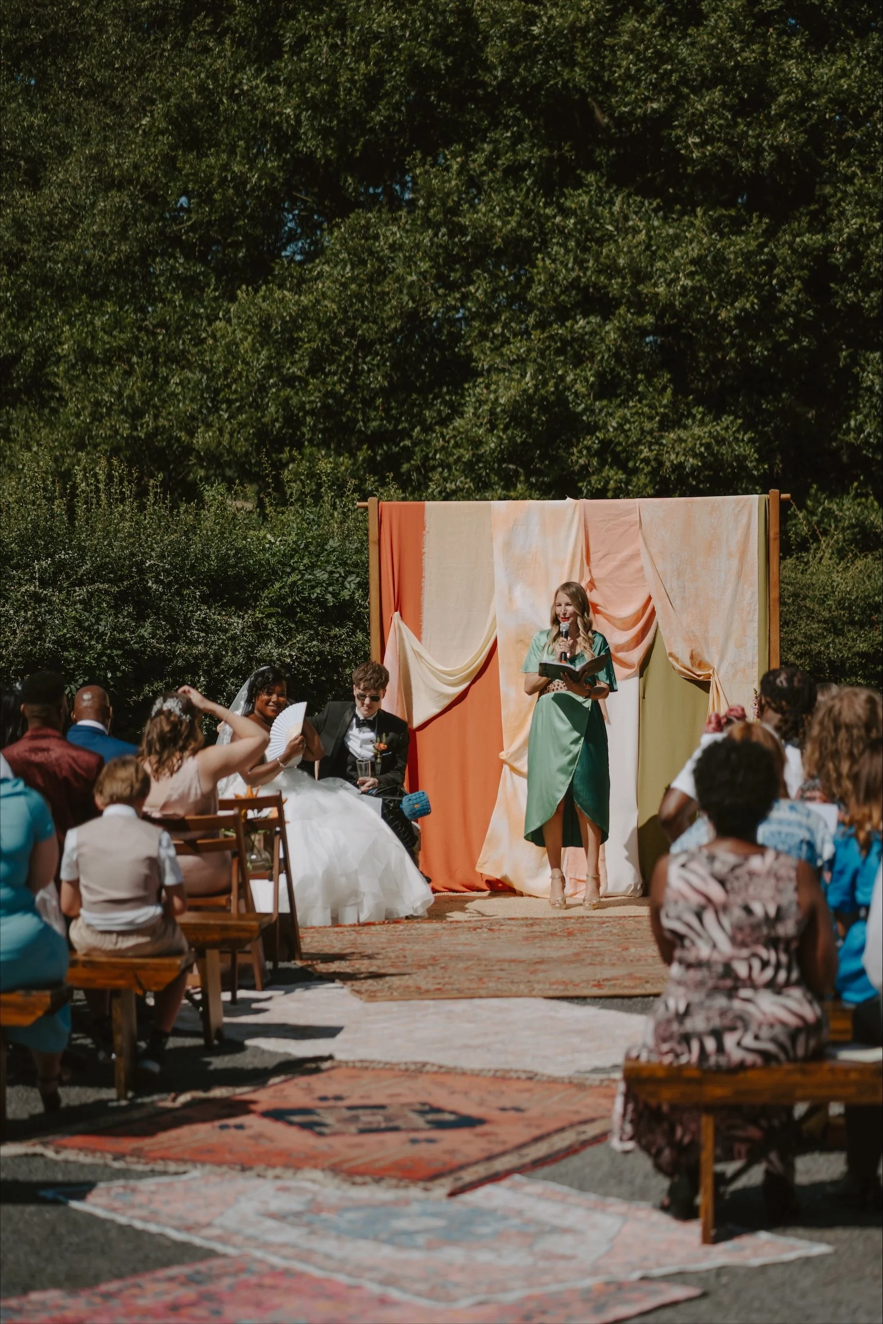 humanist wedding celebrant marrying LGBTQI+ couple in outdoor ceremony