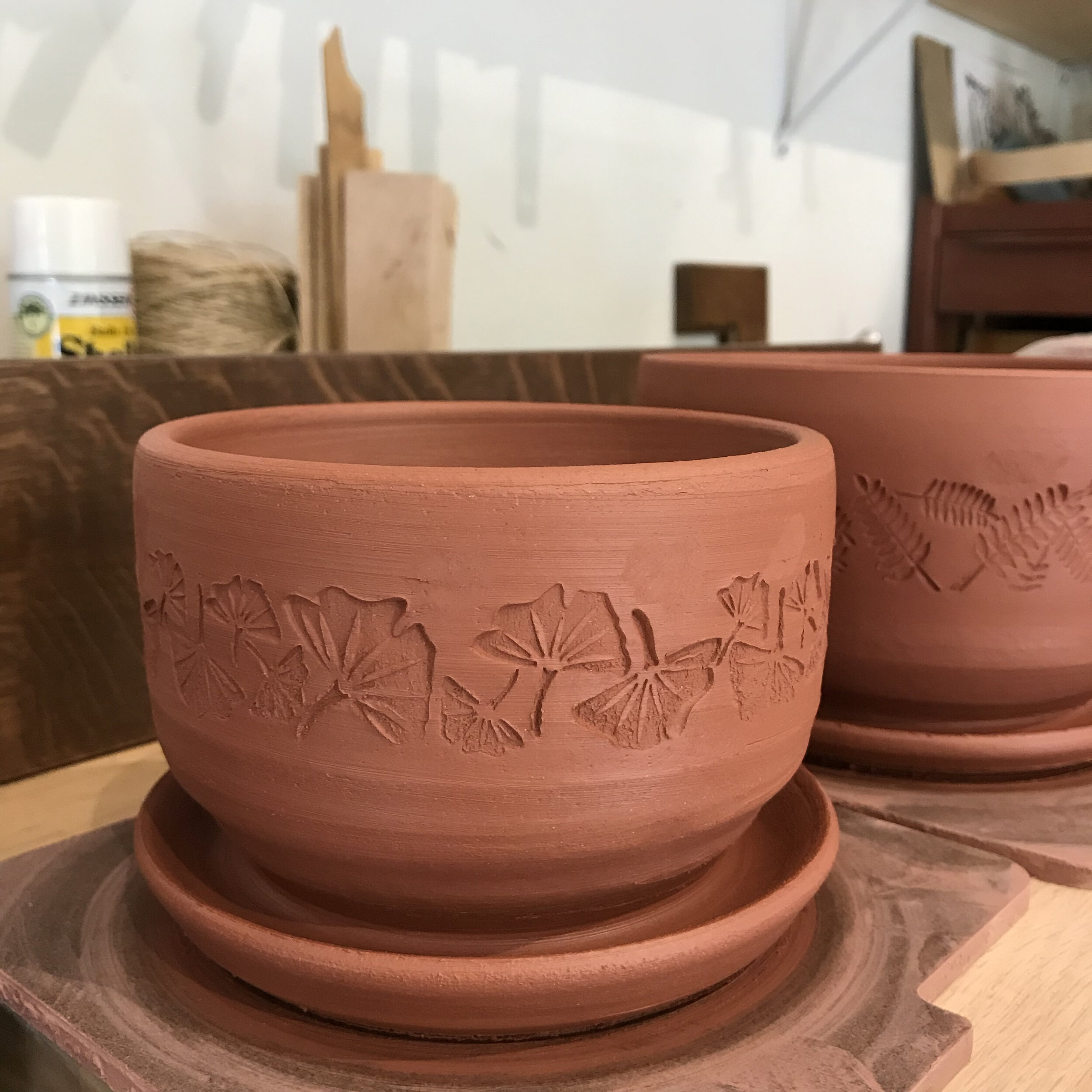 Planters fresh off the potter's wheel. I use stamps and other tools to add patterns and texture to my work.