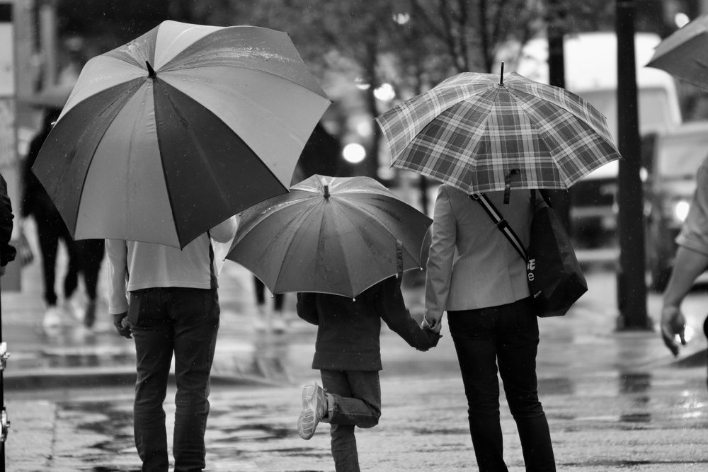 co-parenting family with umbrellas