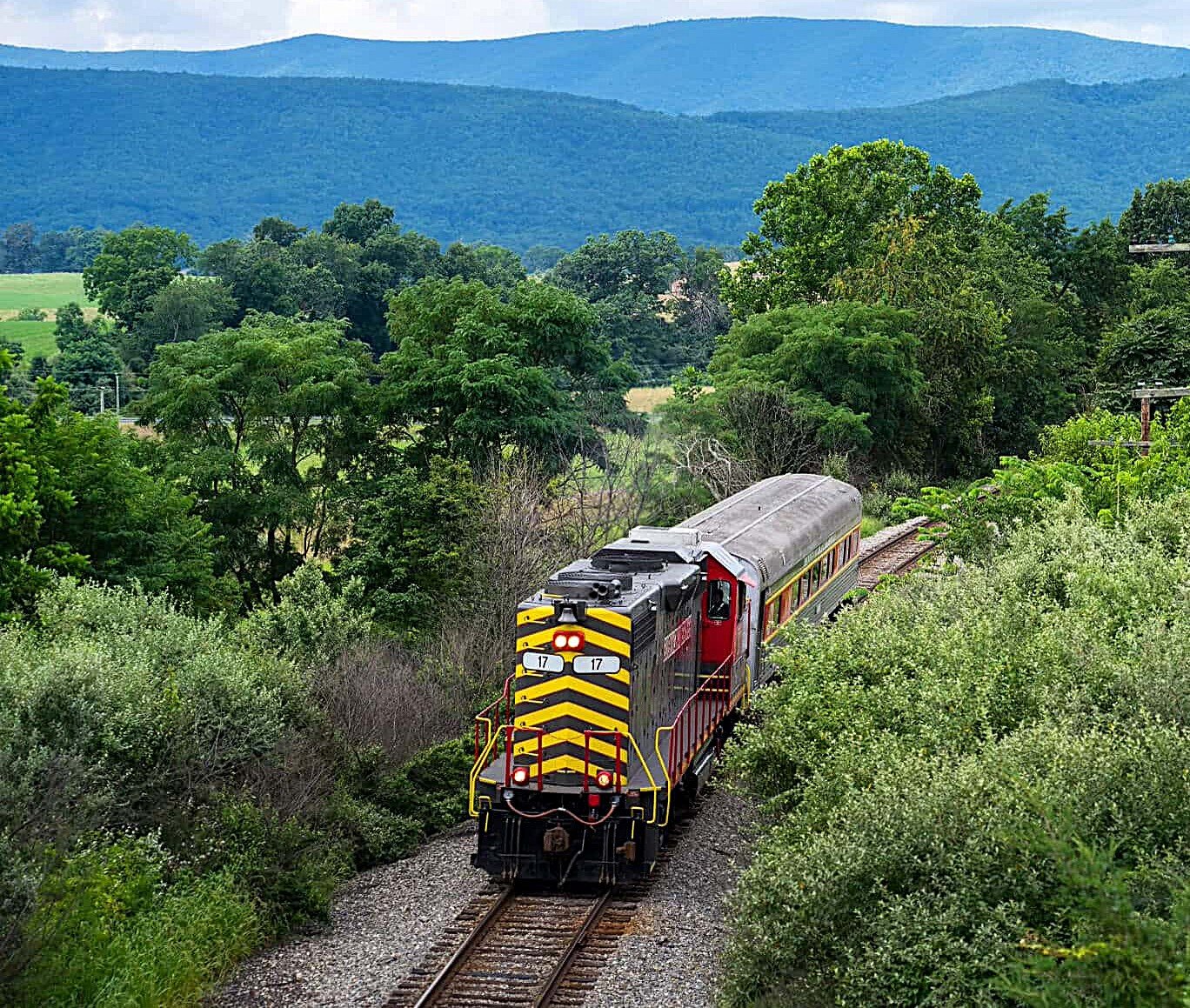 Locomotive with single car on railroad