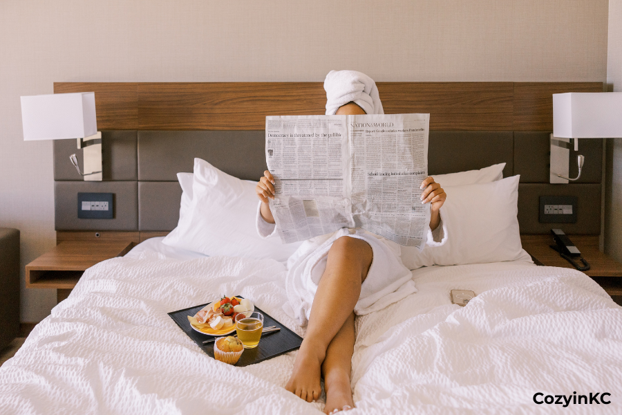 Guest relaxing in bed with breakfast tray at a CozyinKC Kansas City vacation rental