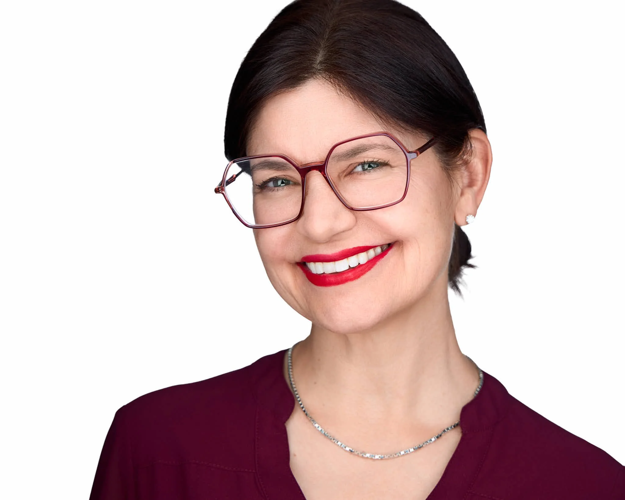 Woman wearing simple earrings and a delicate necklace for a professional headshot
