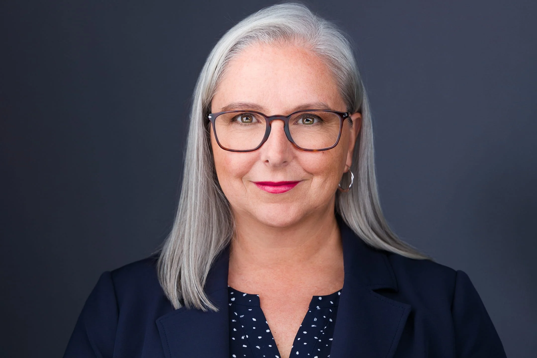 Woman wearing clothing with minimal patterns for a professional headshot