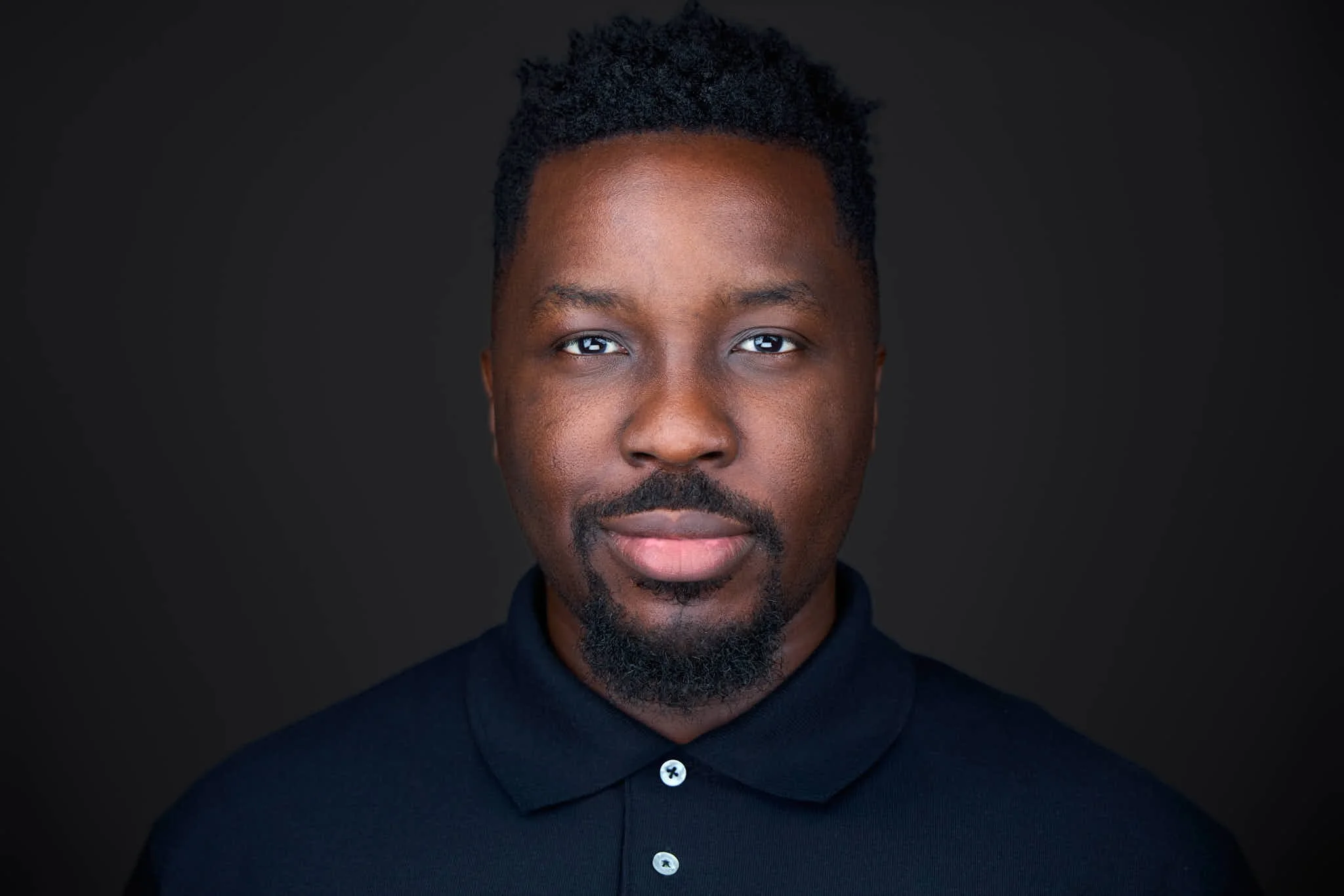 Professional headshot with a grey background from a photoshoot for LinkedIn profile