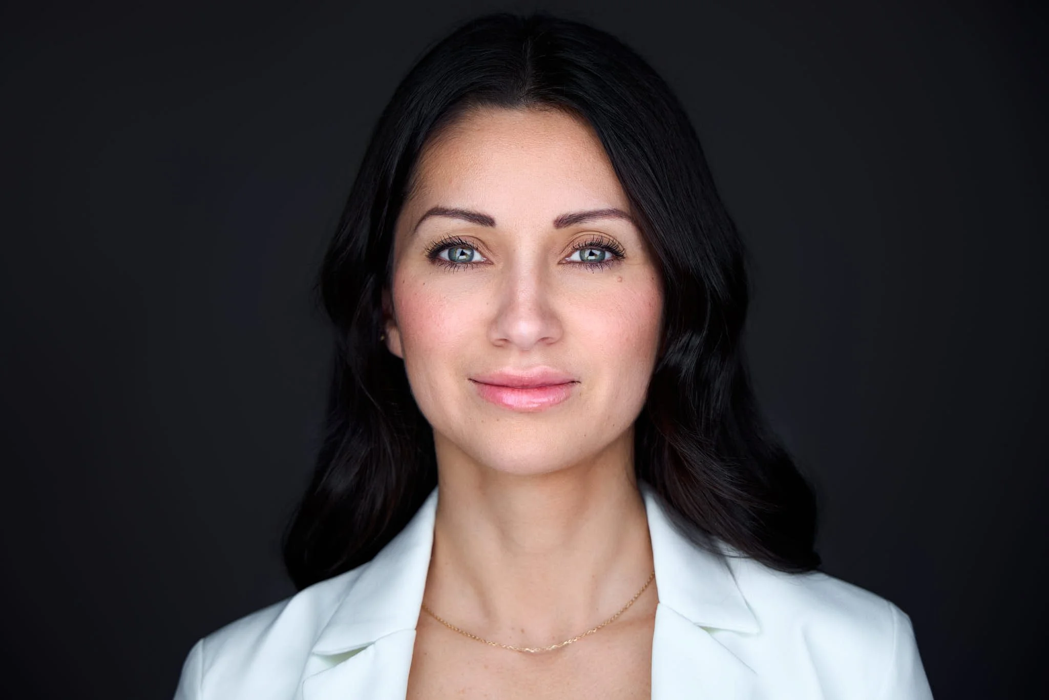 Woman wearing a white suit jacket for a professional headshot