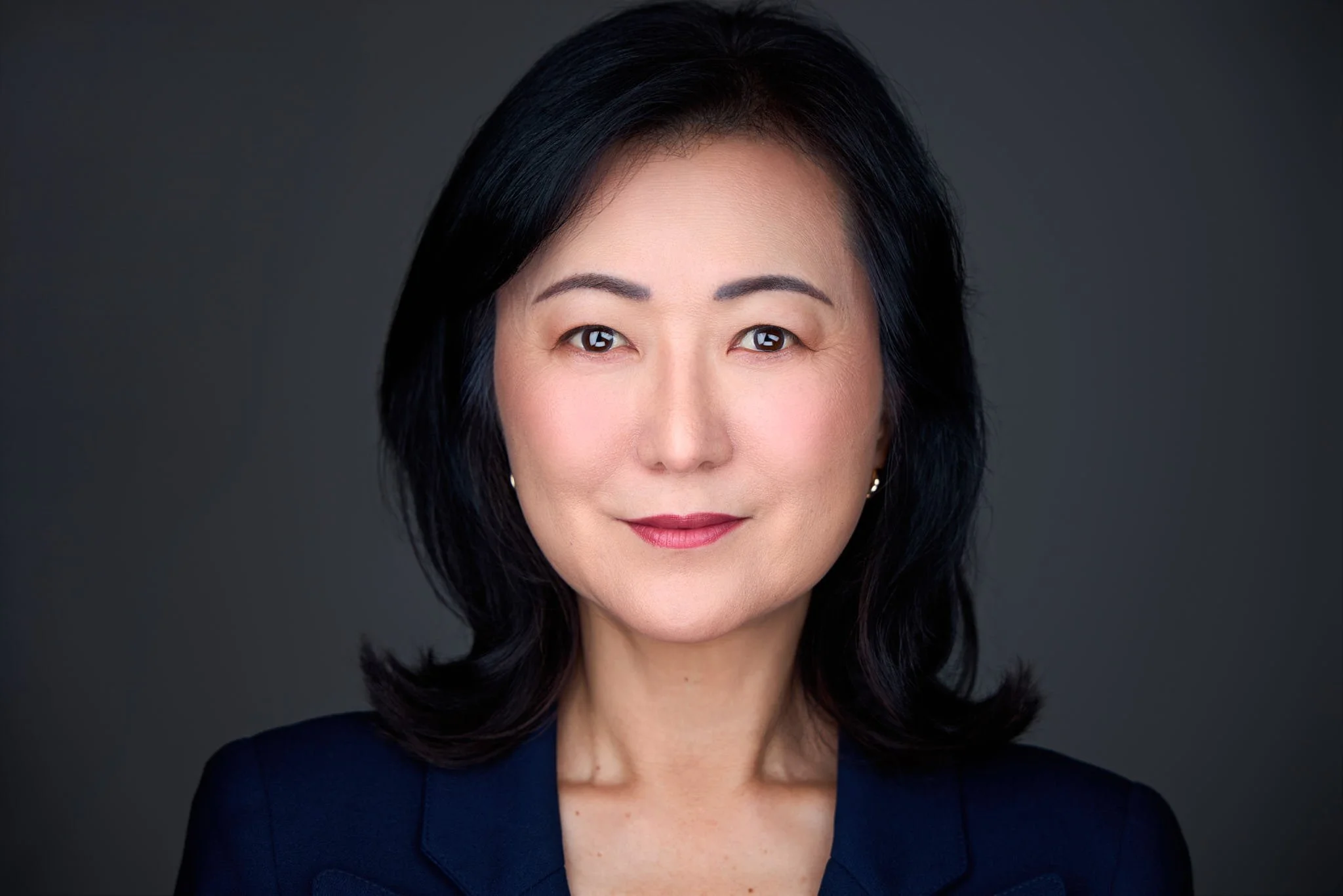 Professional headshot of a banker with a navy blue suit