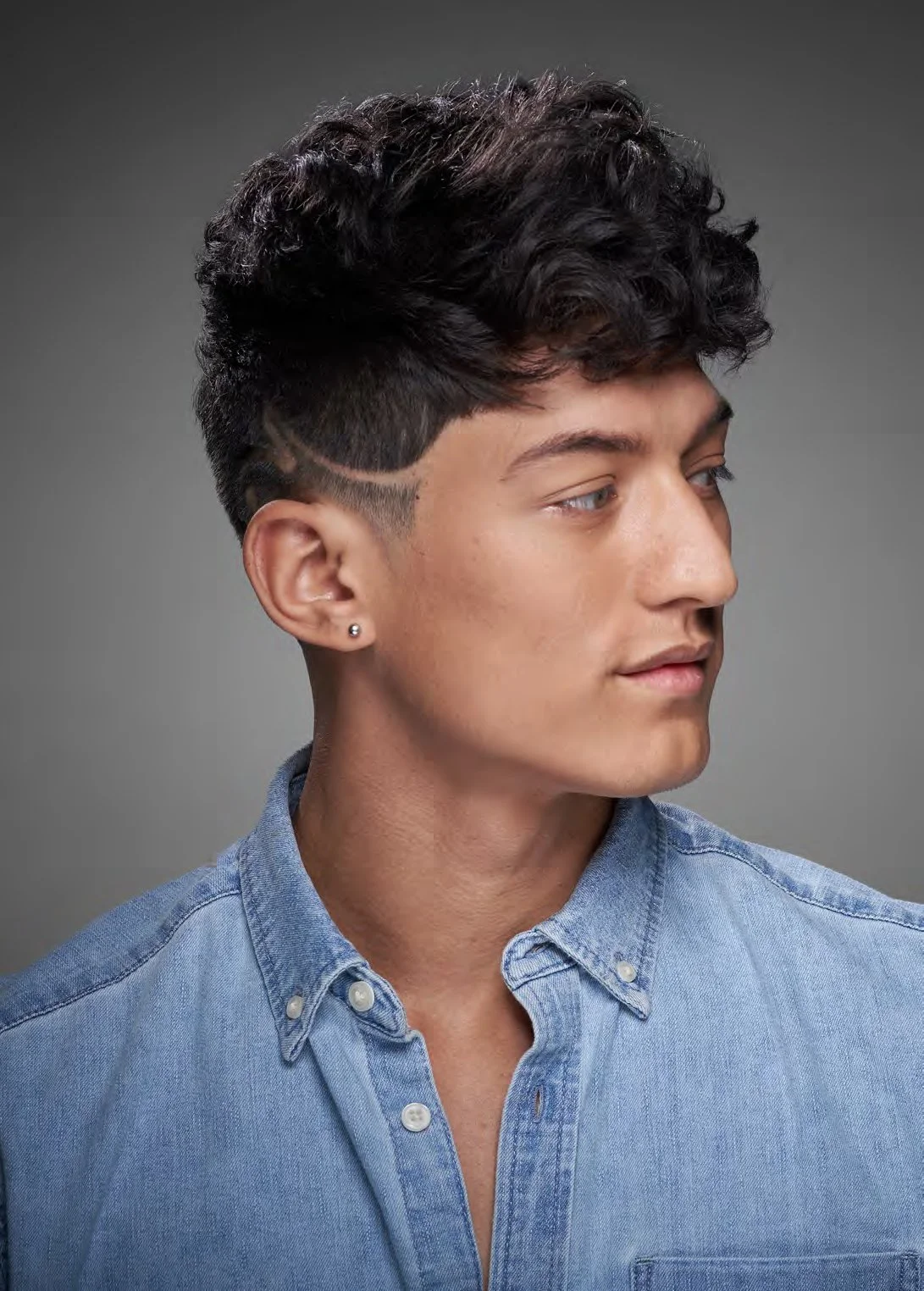 Man with stylish haircut and denim shirt