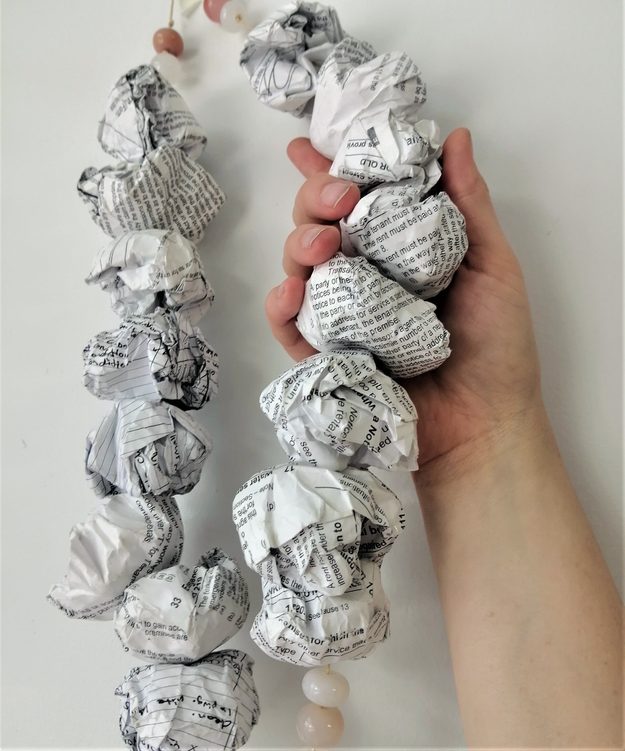 Rental Panic, 2016 (detail)
Sterling silver, brass, agate beads, paper beads made from lease documents, gloss varnish. Private Collection