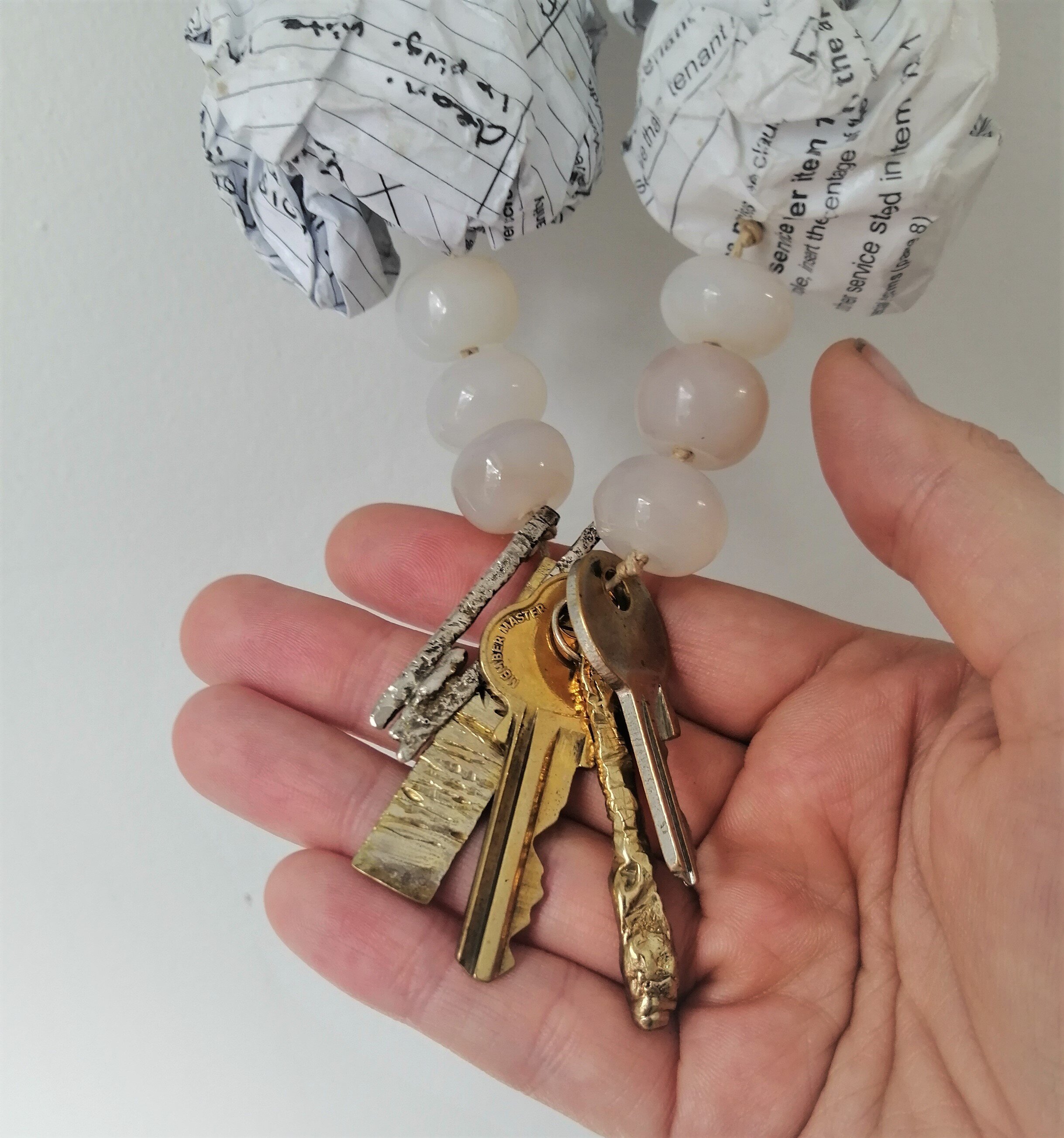 Rental Panic, 2016 (detail)
Sterling silver, brass, agate beads, paper beads made from lease documents, gloss varnish. Private Collection