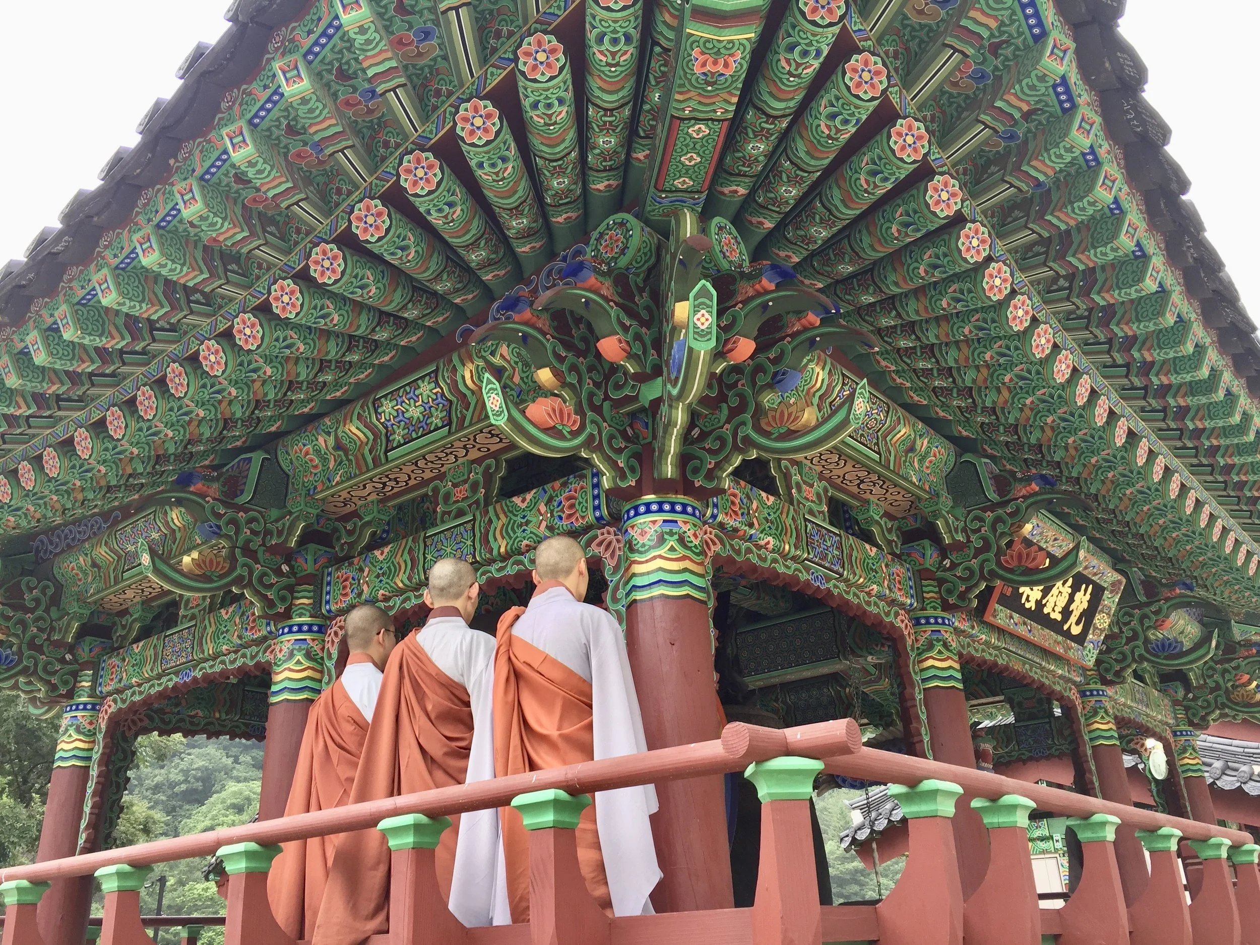 Photograph of Baekdamsa Temple set against a forested mountain slope in Seoraksan, South Korea, showing temple buildings and forests in the background