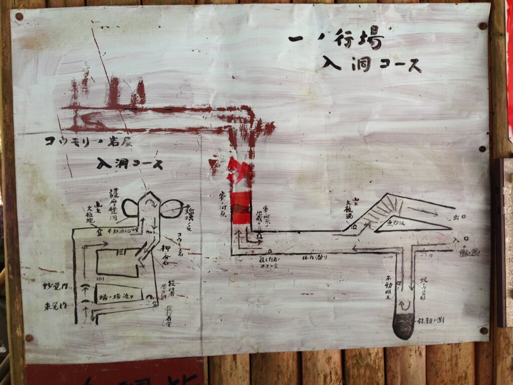 A whiteboard with a hand-drawn map or diagram in Japanese, showing an underground course or tunnel system with various labels and arrows.