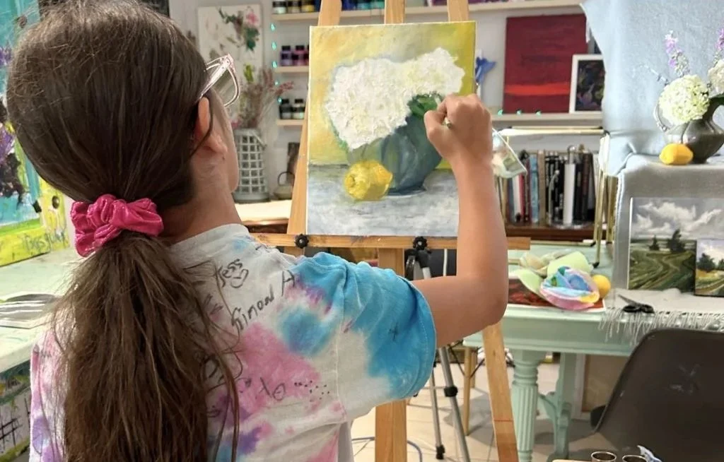 Girl painting a flower pot