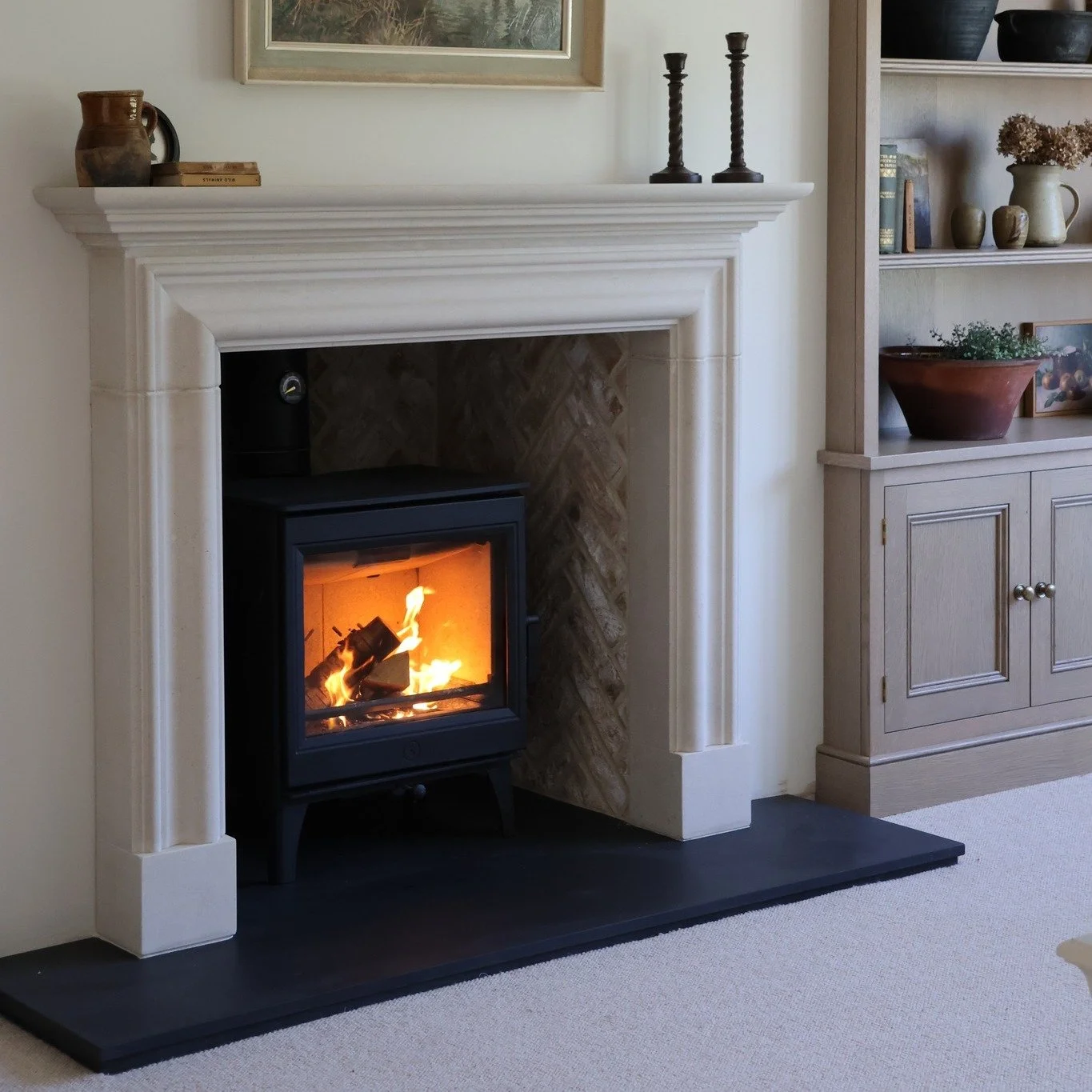 This has got to be one of our favourite installs of the year..........

So we are not going to apologise for posting these images again. This is our Fraser fireplace handmade in Portland Stone, matched with a wood burning stove from  @charnwoodstoves