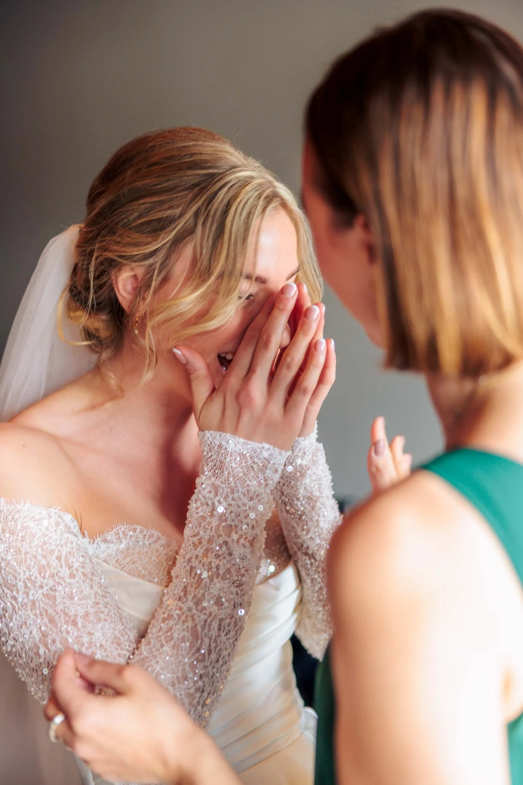 The bridesmaid cries tears of joy as she presents a horn to the bride at a wedding.