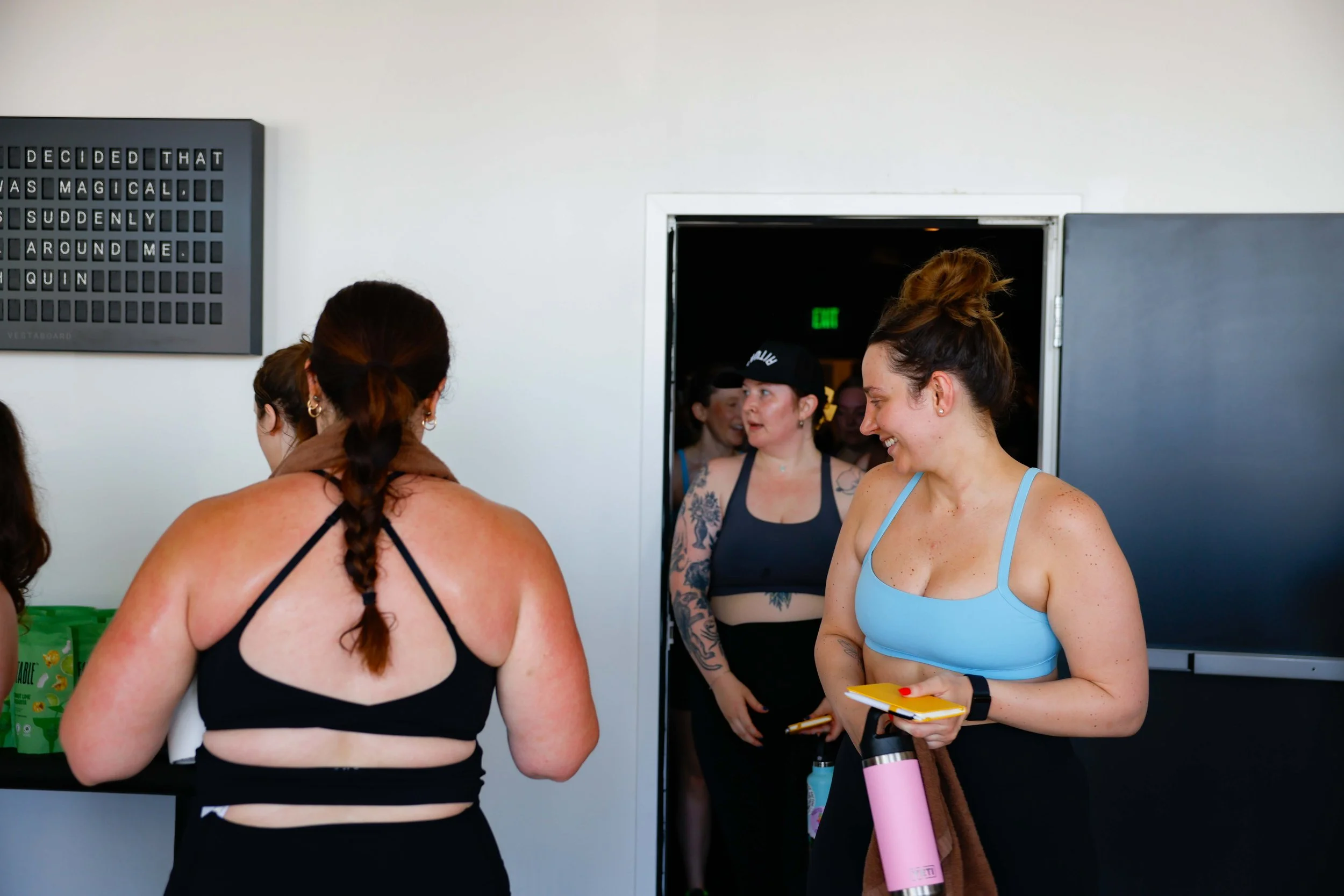 Women exiting an indoor cycling class.
