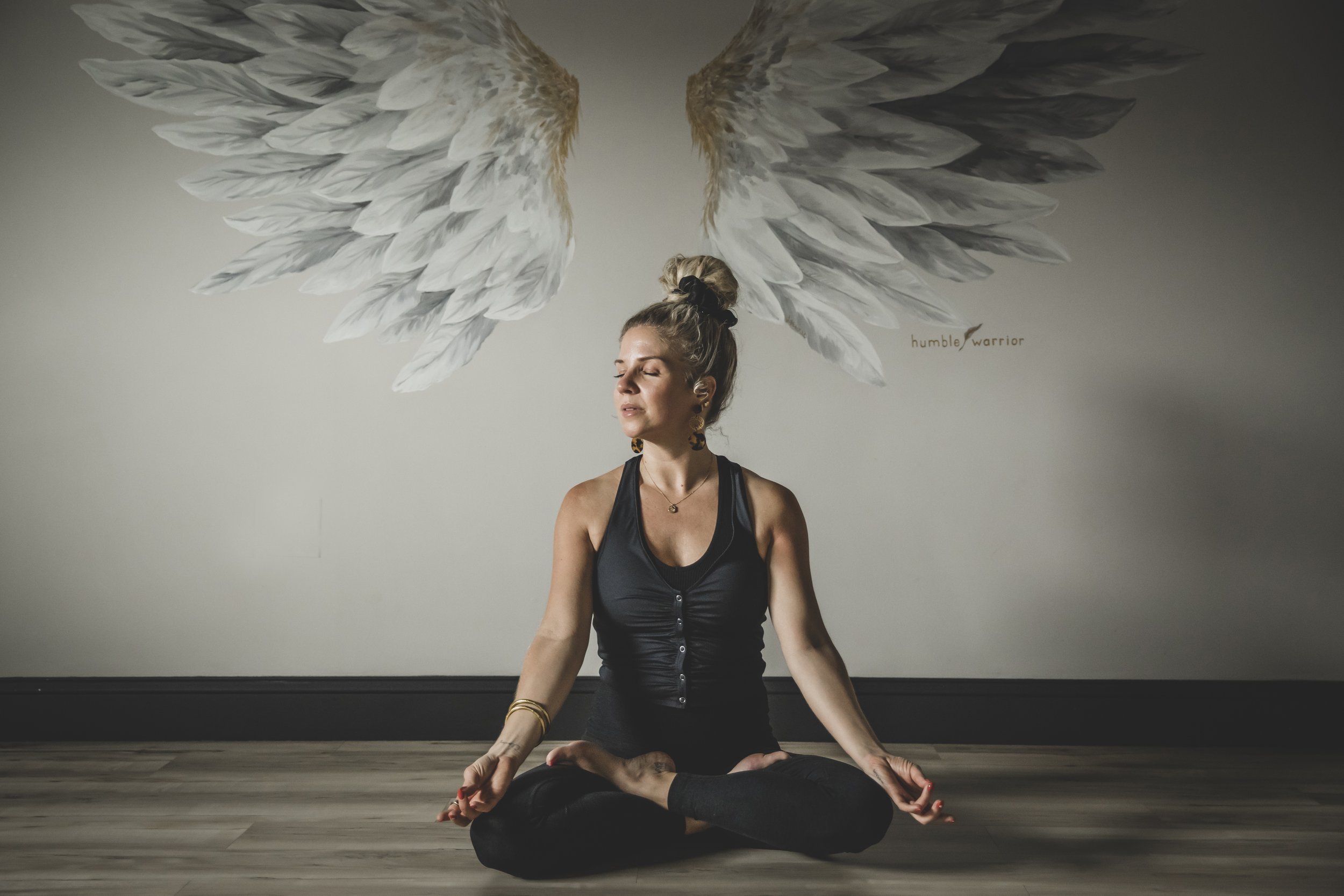 A woman in a meditative pose stretched her neck, eyes closed