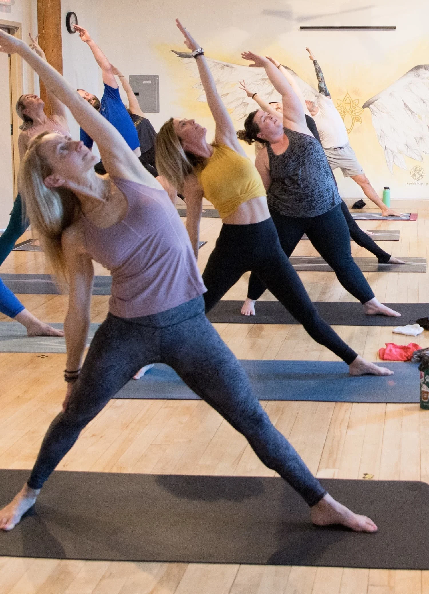 A line of yoga students leaning back into a pose