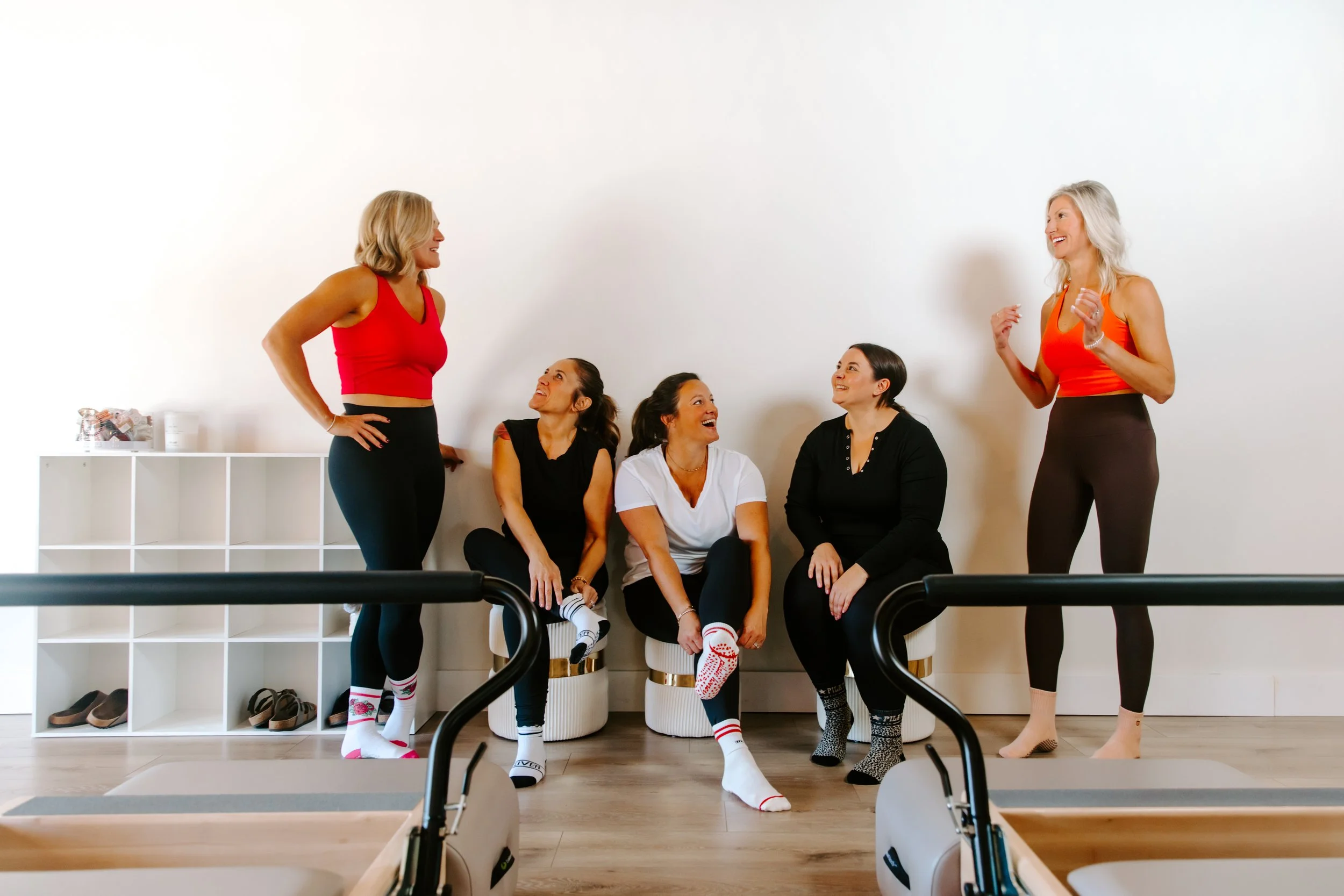 A group of women speaking after a Pilates class