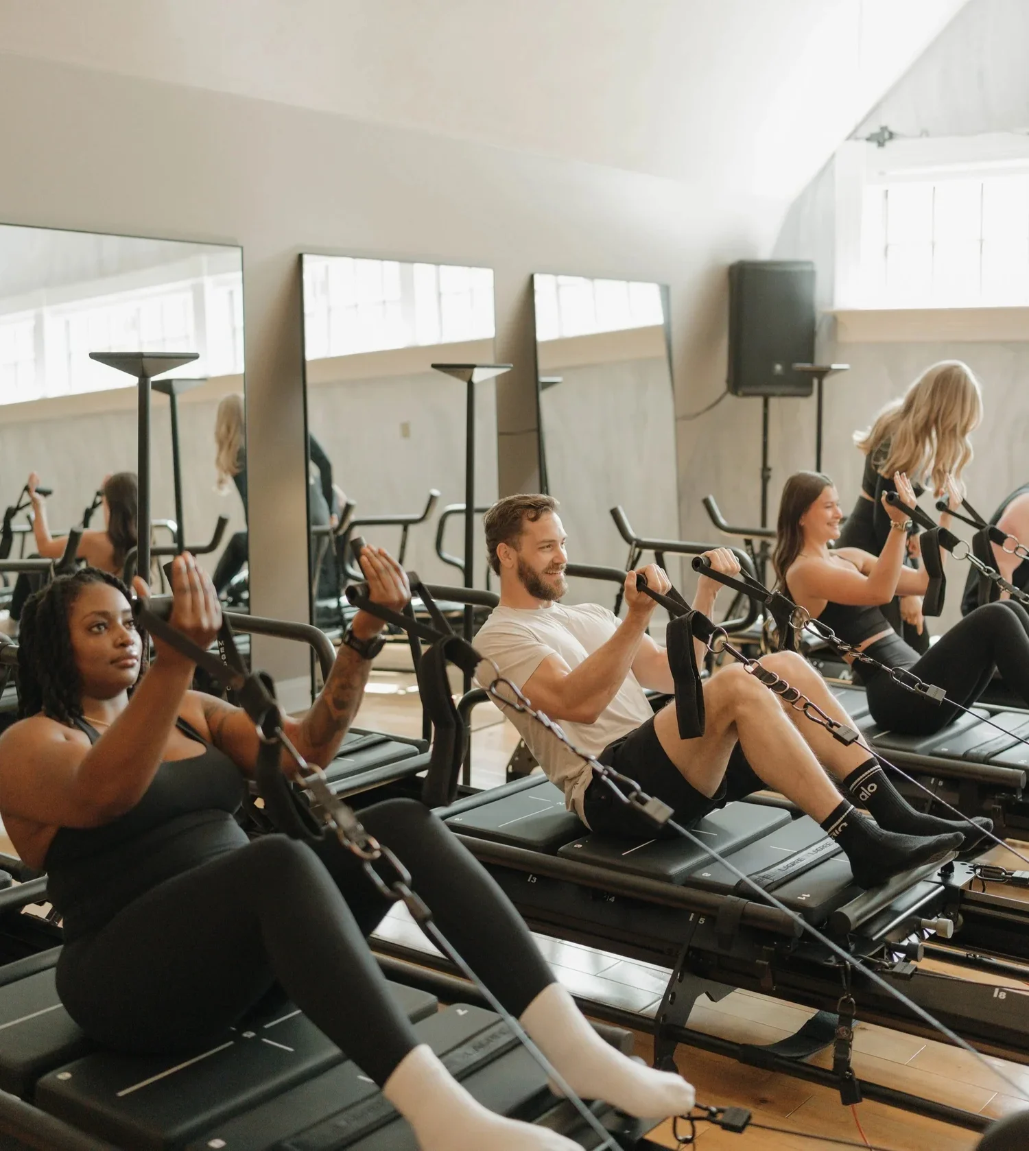 Clients participating in a group reformer workout at a boutique fitness studio