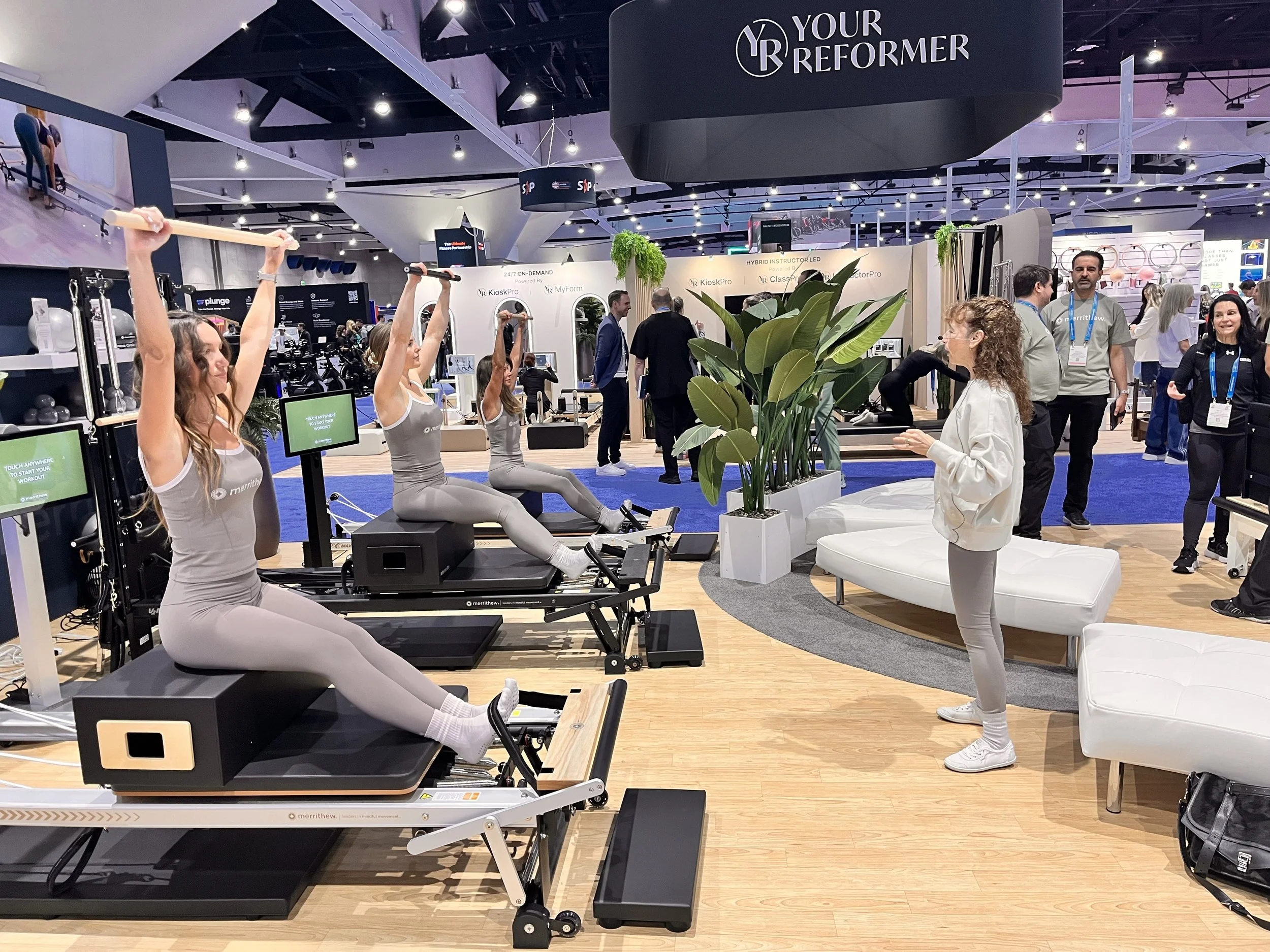 Trade show vendors demonstrating the latest Reformer technology.