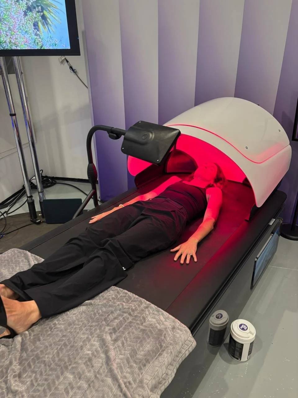 Woman lying down receiving an infrared therapy massage