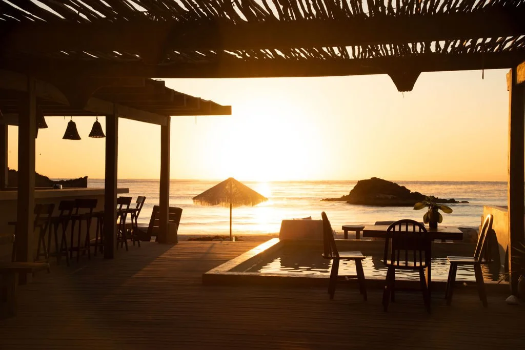 View from a beach bar or little hotel during a sunset at the beach