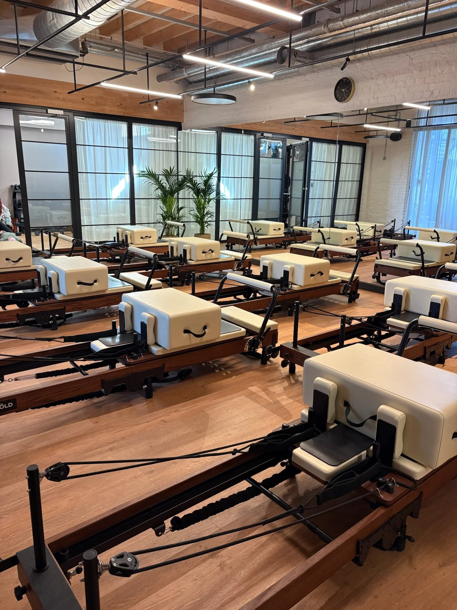 Pilates studio with a room full of reformers