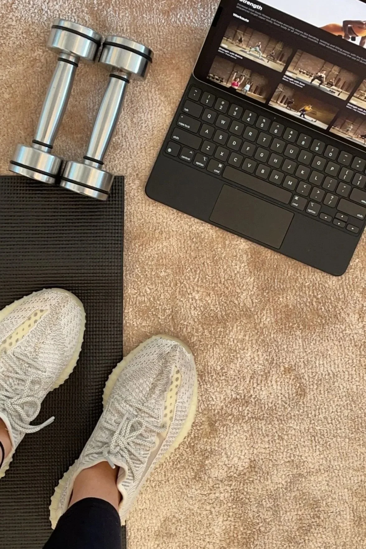 Upper view of an online fitness class with dumbbells