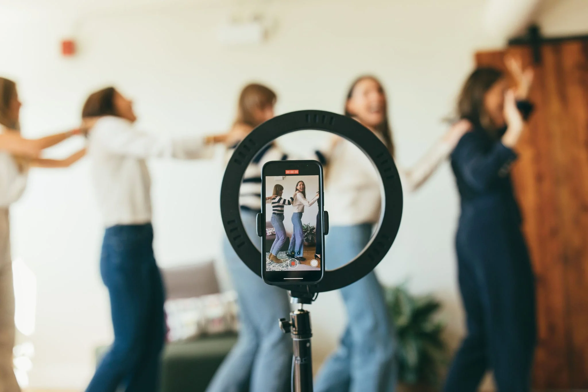 Telomere Consulting team creating content by recording themselves with a phone.